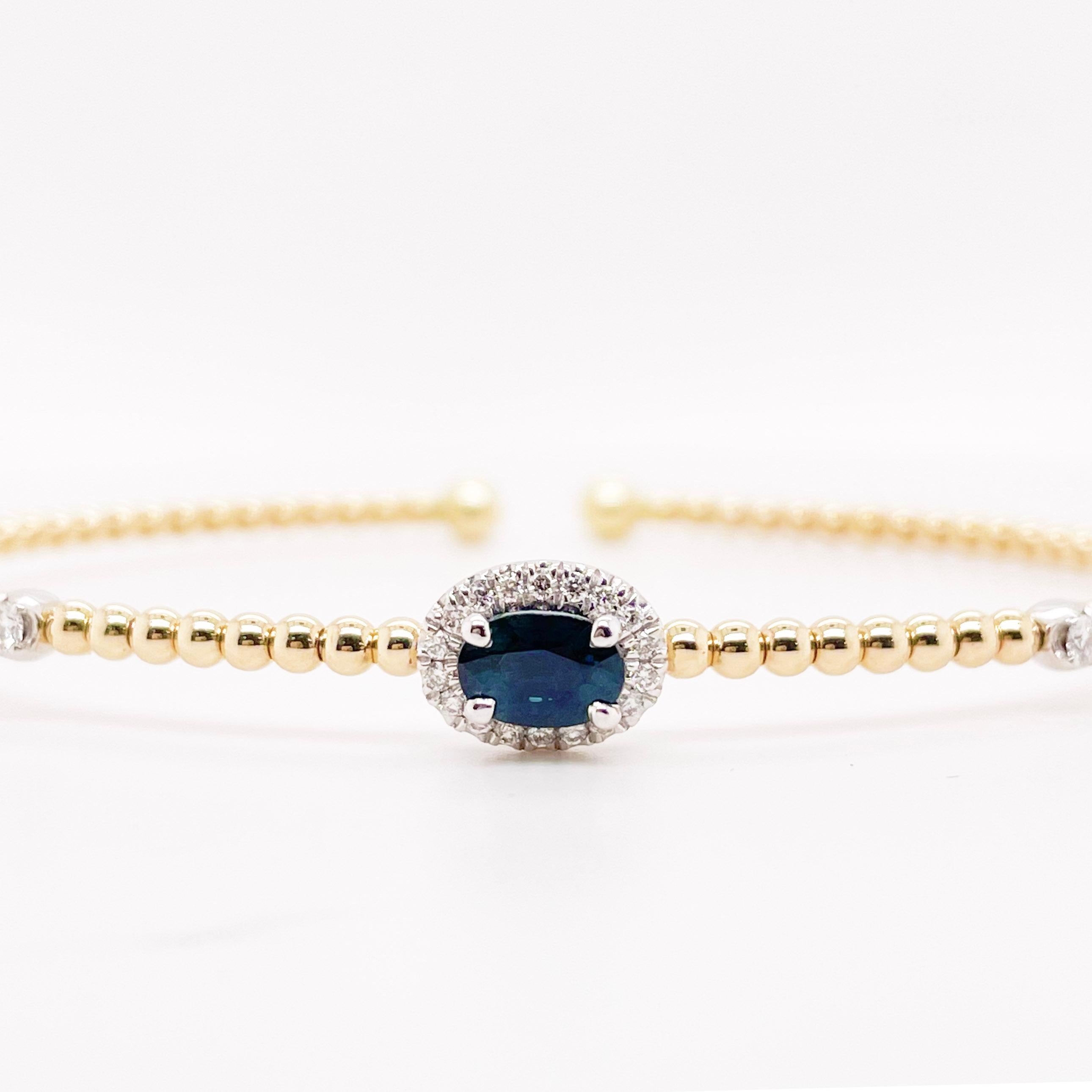 This flexible bracelet is perfect on any wrist. The flex style makes it possible to open the bracelet up and the patented design wraps around your wrist. This bracelet has an oval sapphire surrounded by diamonds set in 14 karat white gold.  The