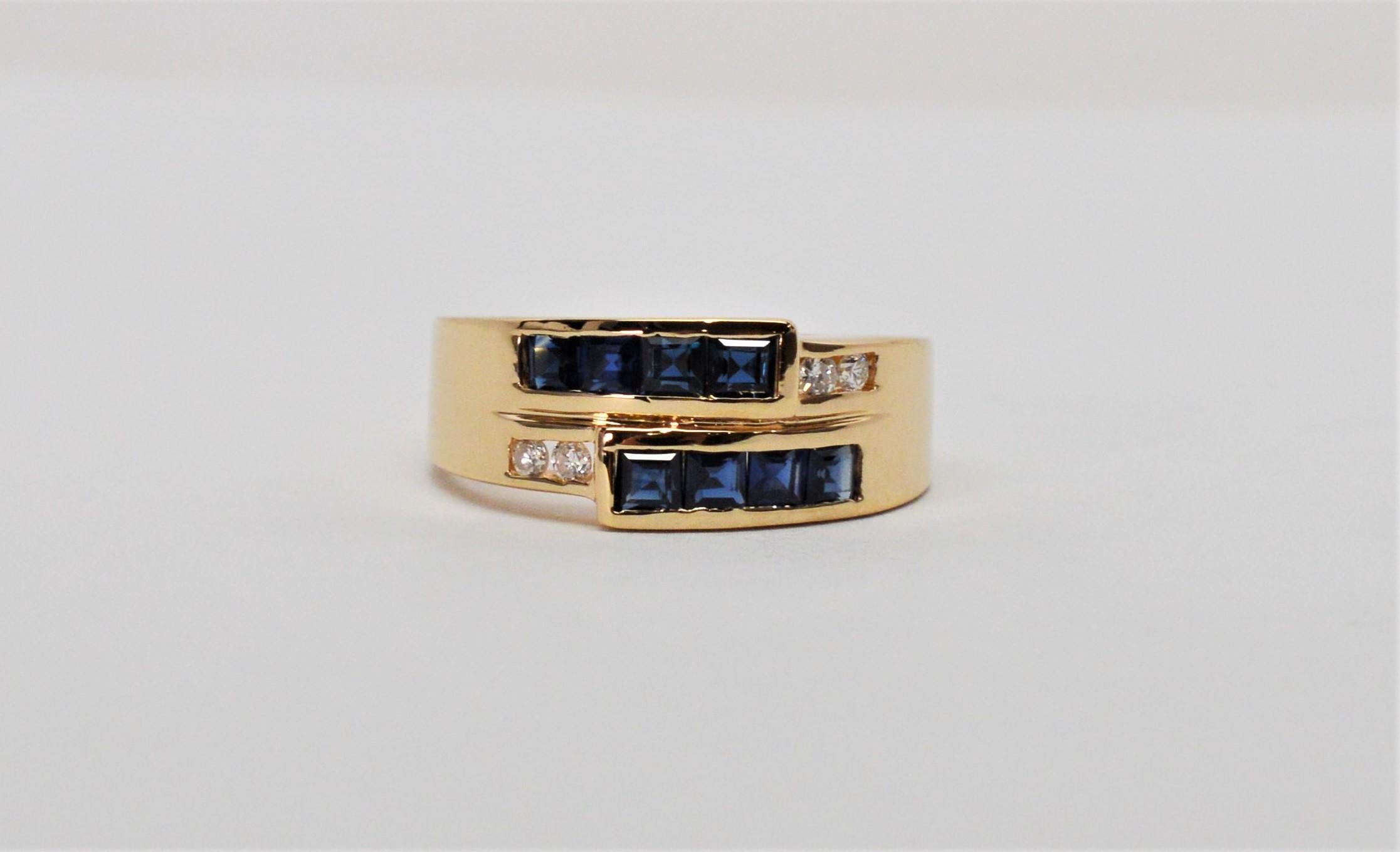 Blue Sapphires with diamond accents are showcased by a wrap effect in this contemporary style ring of this 14 karat yellow gold.  In ring size 6.5, with eight .01 carat sapphires and four .005 carat diamond accents. Gift Box. 