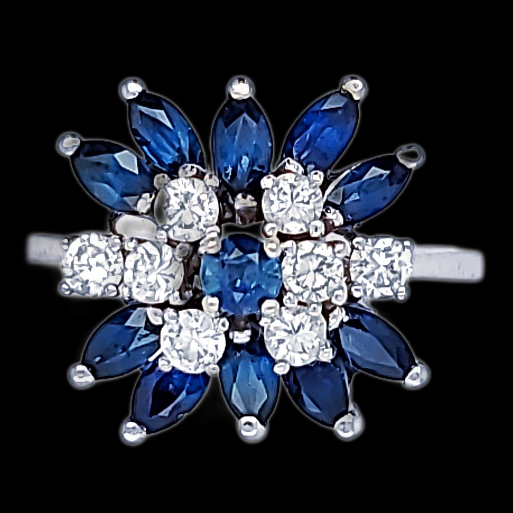 This ring was created in the early 1970s and consists of a Round Center Blue Sapphire, Surrounded by Marquise Shaped Matching Sapphires as well as Round Diamonds.  Diamonds are fine in both clarity and color.  Stamped 14kt with a Makers Hallmark of