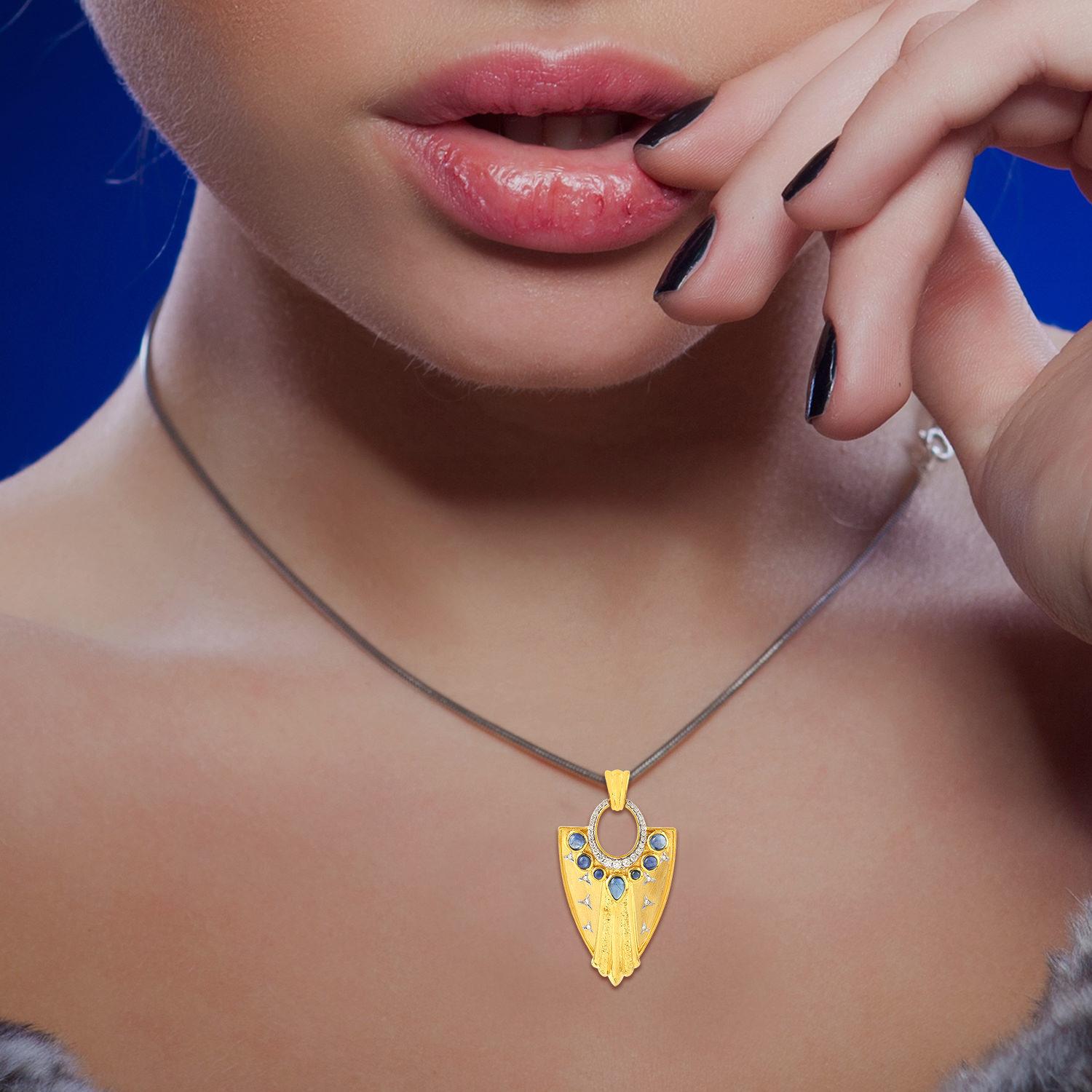 Cast in 14 Karat gold, this beautiful warrior pendant is hand finished in matte yellow gold, 2.2 carats blue sapphire & .45 carats of sparkling diamonds.  

FOLLOW  MEGHNA JEWELS storefront to view the latest collection & exclusive pieces.  Meghna