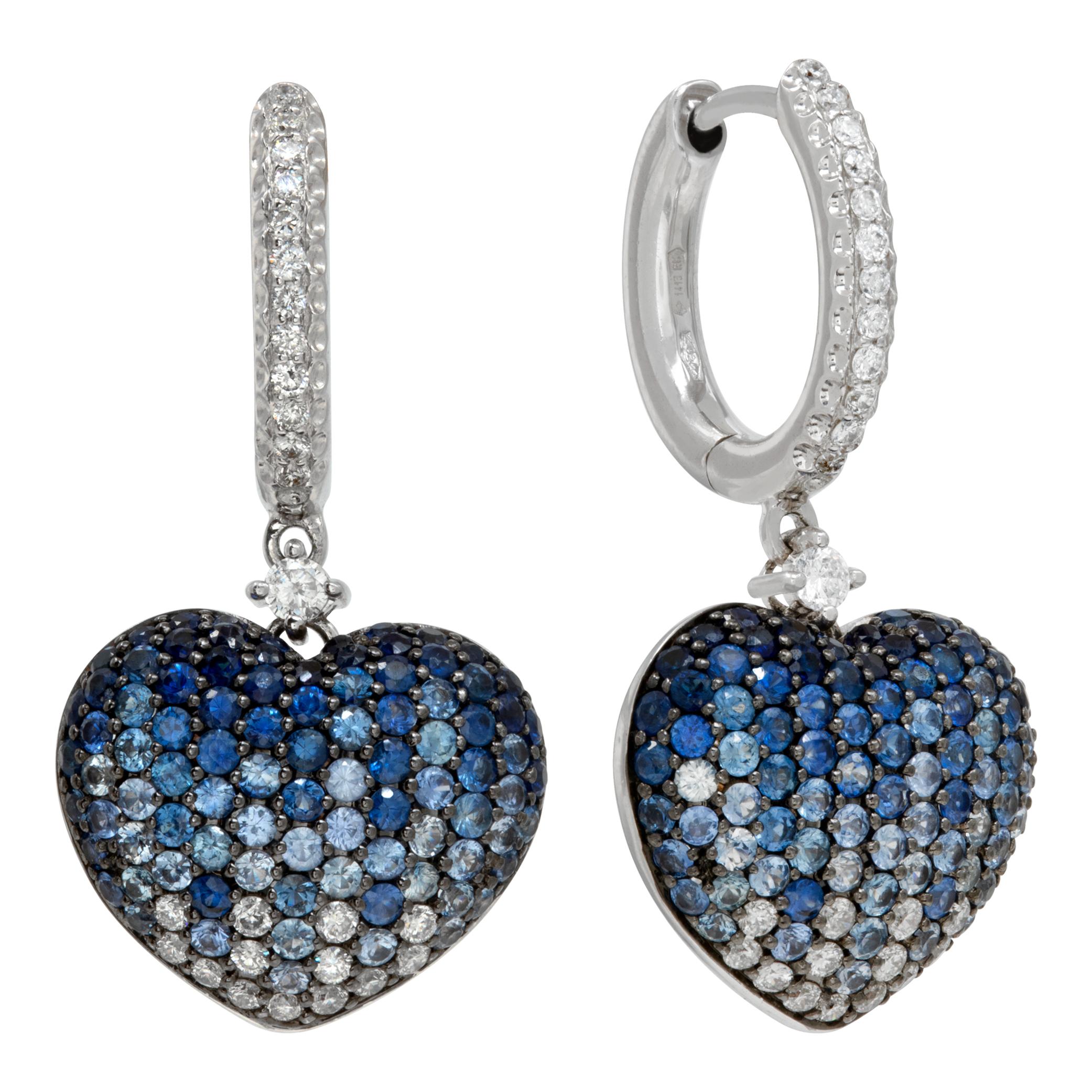 Dangling sapphire & diamond heart earrings in 18k white gold. Approximately 0.47 carats in diamonds and 2.13 carats in blue sapphires. 1.25 inch hanging length.