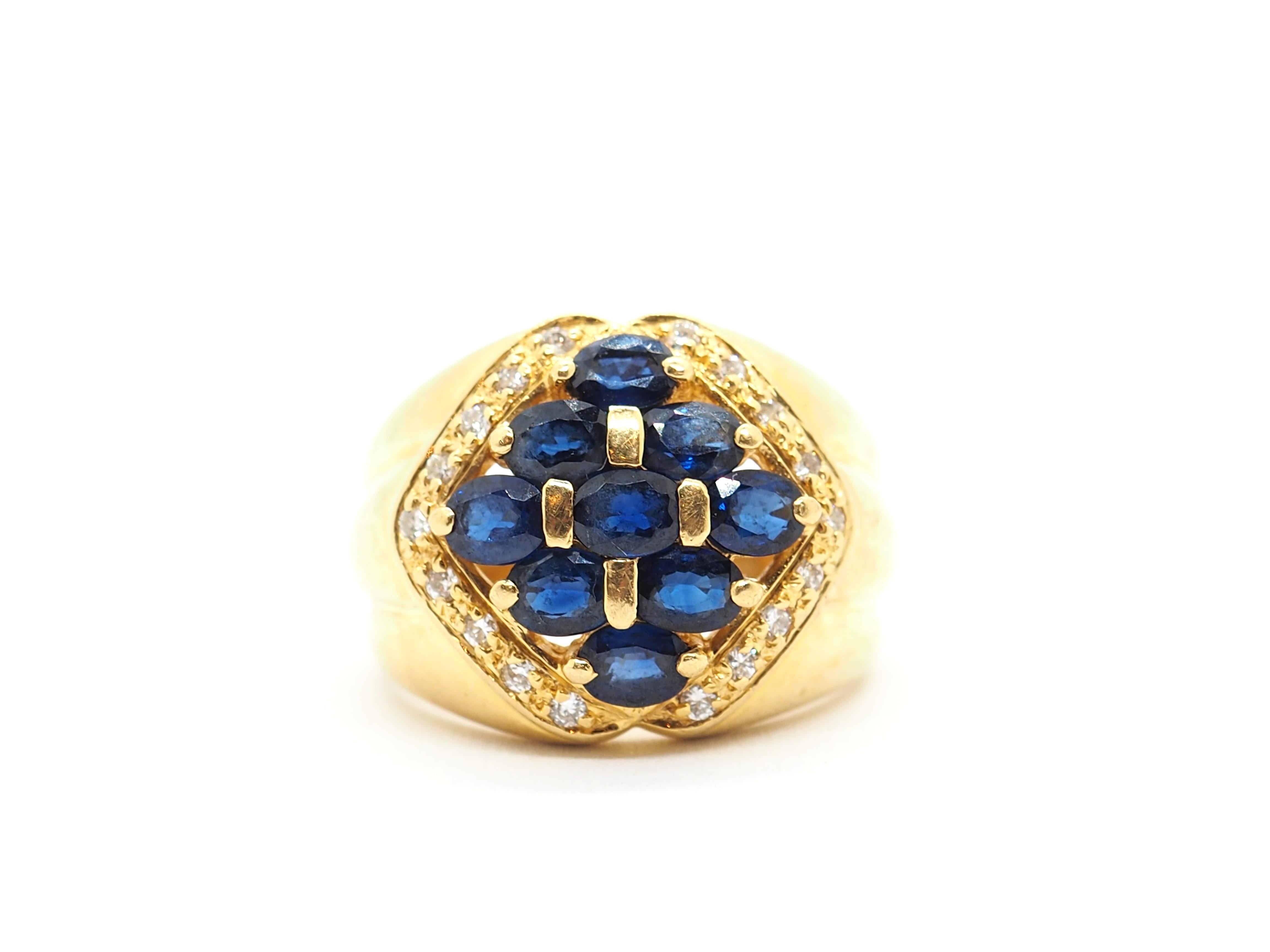 The ring made in 18k yellow gold and features a beautiful oval-shaped centerpiece comprised of nine sapphires in a deep, rich blue hue. The sapphires are arranged in a symmetrical pattern that creates a sense of balance and harmony.

Surrounding the