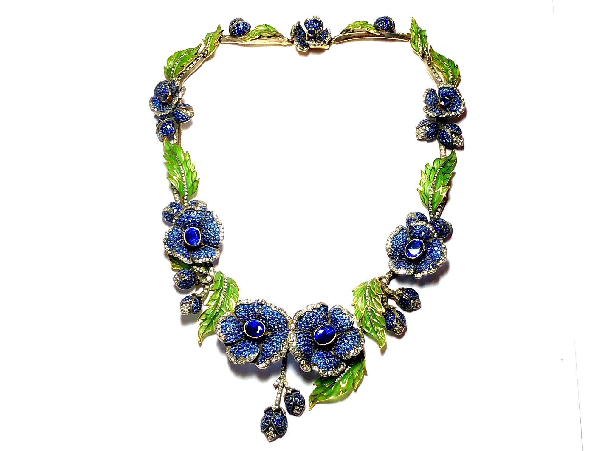 A Moira flower necklace, with green plique à jour enamel leaves, pavé set sapphires and eight-cut diamonds, mounted in gold, with silver settings, signed Moira numbered 6238. Moiras eponymous collection was inspired by clients searching for unusual