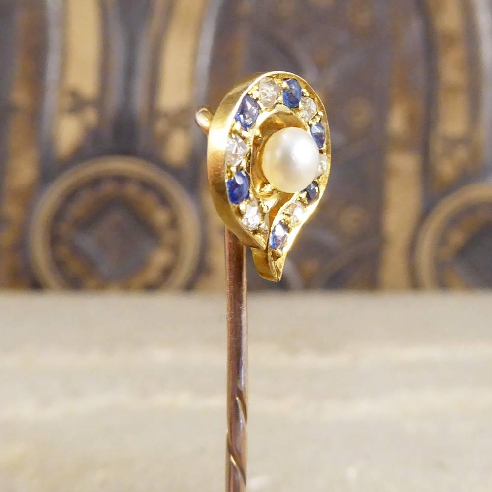 Sometimes a dainty stick pin is the perfect little addition to an outfit. This gorgeous Late Victorian 9ct yellow Gold pin holds 6 small Diamonds and 6 small Sapphires surrounding one single Pearl on a 15ct Yellow Gold head.

Condition: Very Good,