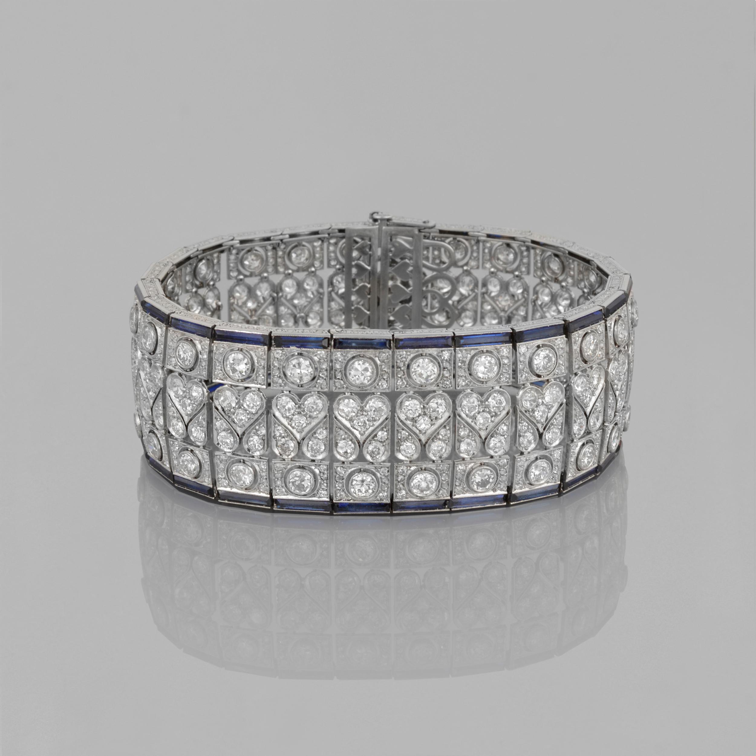 This stunning bracelet is from France and was made during the Art Deco period. It is a wide articulated band with a stunning open work geometric design. It is a milgrain circular set with single cut diamonds. The band edges are made with calibre-cut