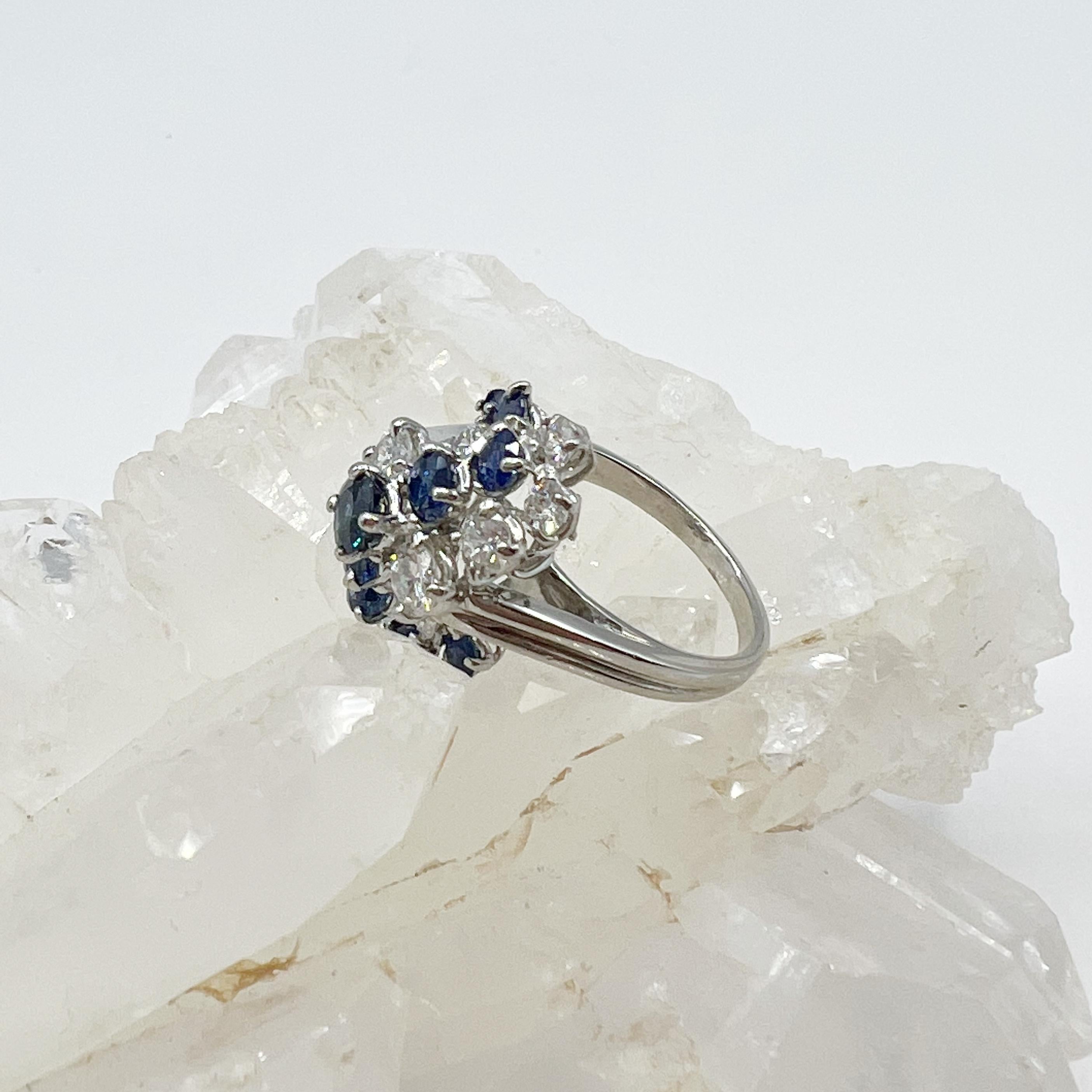 This stunner is a multitude of round faceted diamonds and sapphires creating a galaxy of sparkle. The diamonds measure approximately 1..20 total carat weight. The diamonds are F/G color and VS1/VS2 quality. The sapphires measure approximately .65