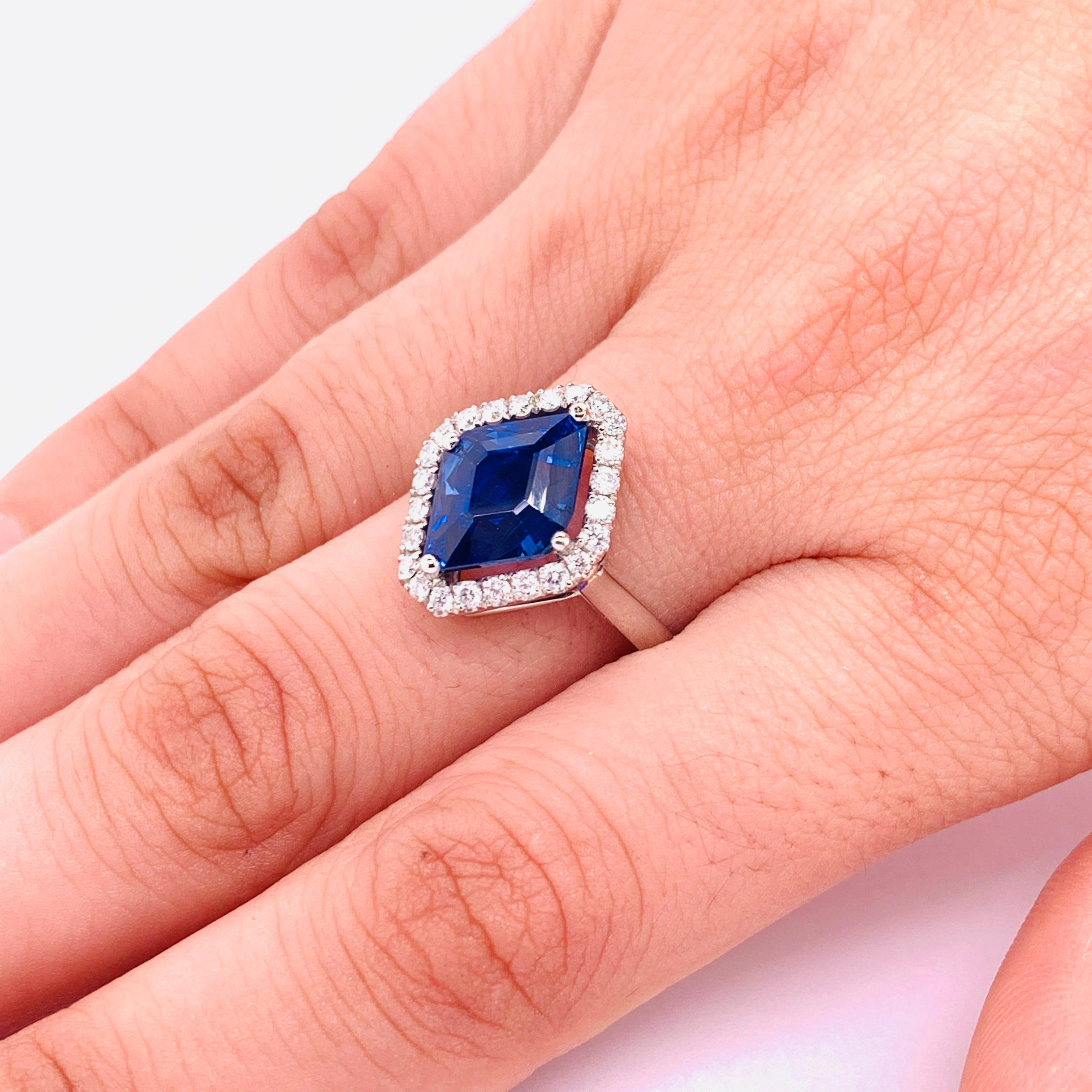A sapphire and diamond ring, set with a cornered-cut, lozenge shape Ceylon sapphire, weighing approximately 4.81ct, in a four claw setting, with a border of 30, round brilliant-cut diamonds, with a total weight of 0.40ct, mounted in platinum,
