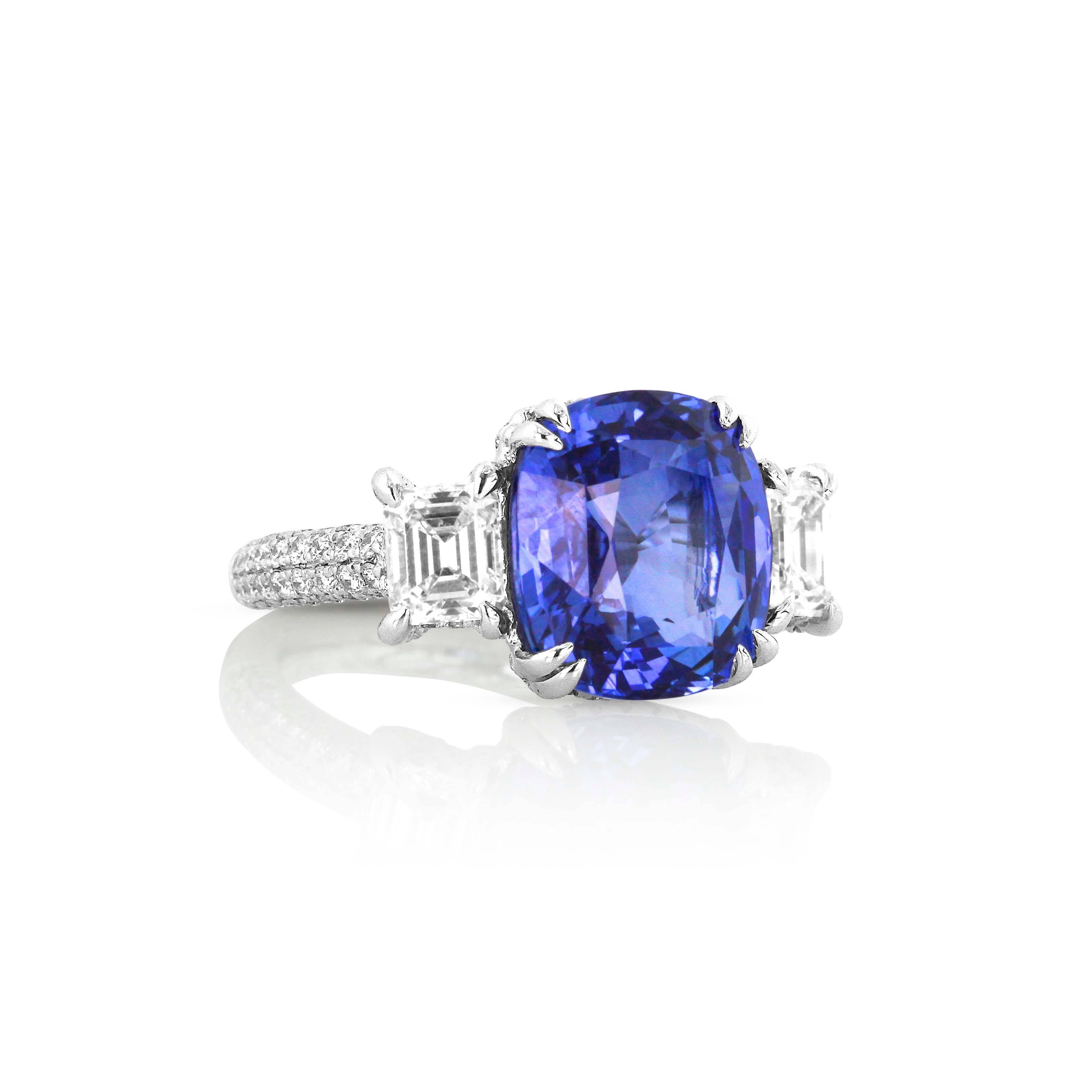 A diamond encrusted ring centers a magnificent blue sapphire accented with rectangular-shaped diamonds at the shoulders. The strong rectangular lines of the diamonds emphasis the softer cushion-shape of the sapphire to create an alluring