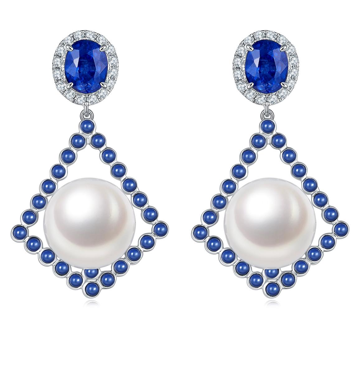 This is a pair of kite shape dangle Earring. The White South Sea Pearl is sitting on top of the kite geometric and surrounded by little Sapphire cabochon. It is then suspended below the oval shape faceted Sapphire, which is encrusted in a circle of