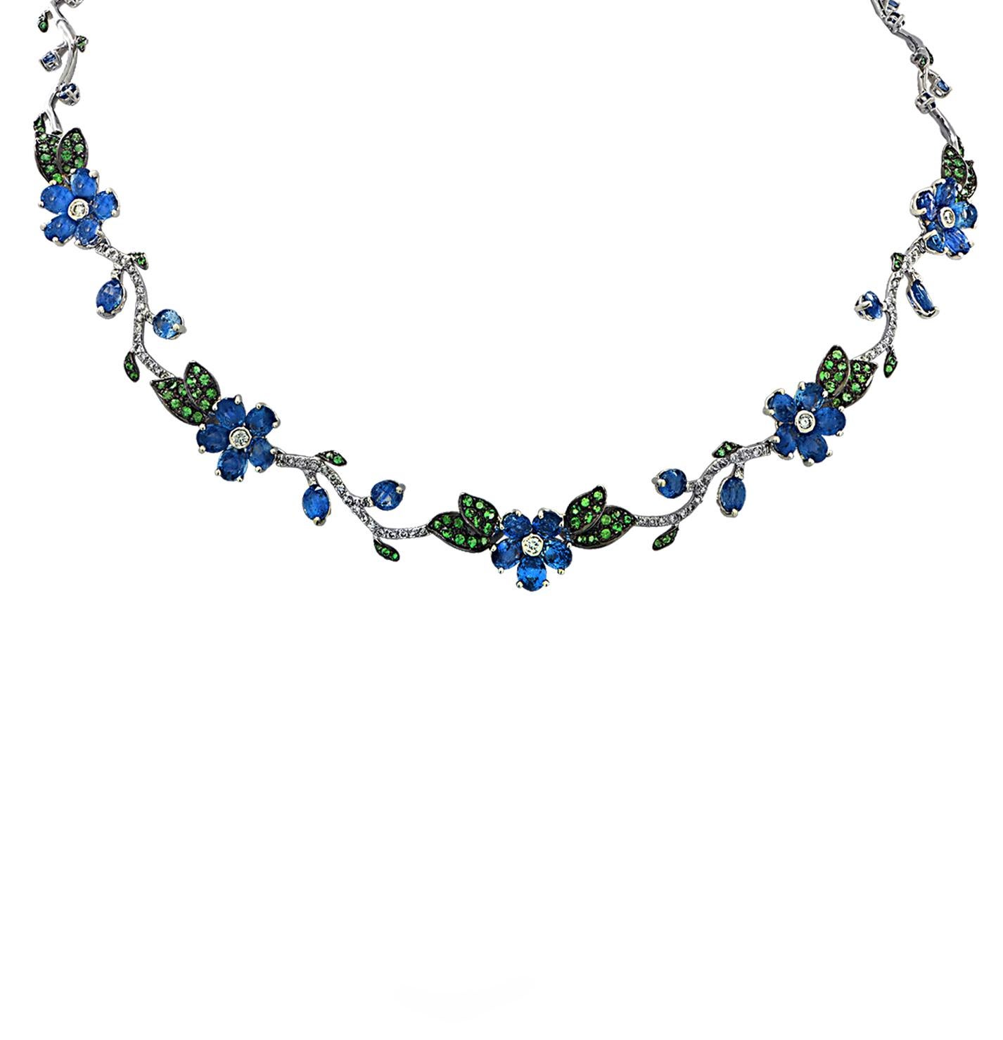 Enchanting sapphire, diamond and tsavorite necklace and earring set crafted in 18 karat white gold featuring 77 mixed cut Blue Sapphires weighing approximately 33.16 carats total, 224 round Green Tsavorite Garnets weighing approximately 2.68 carats