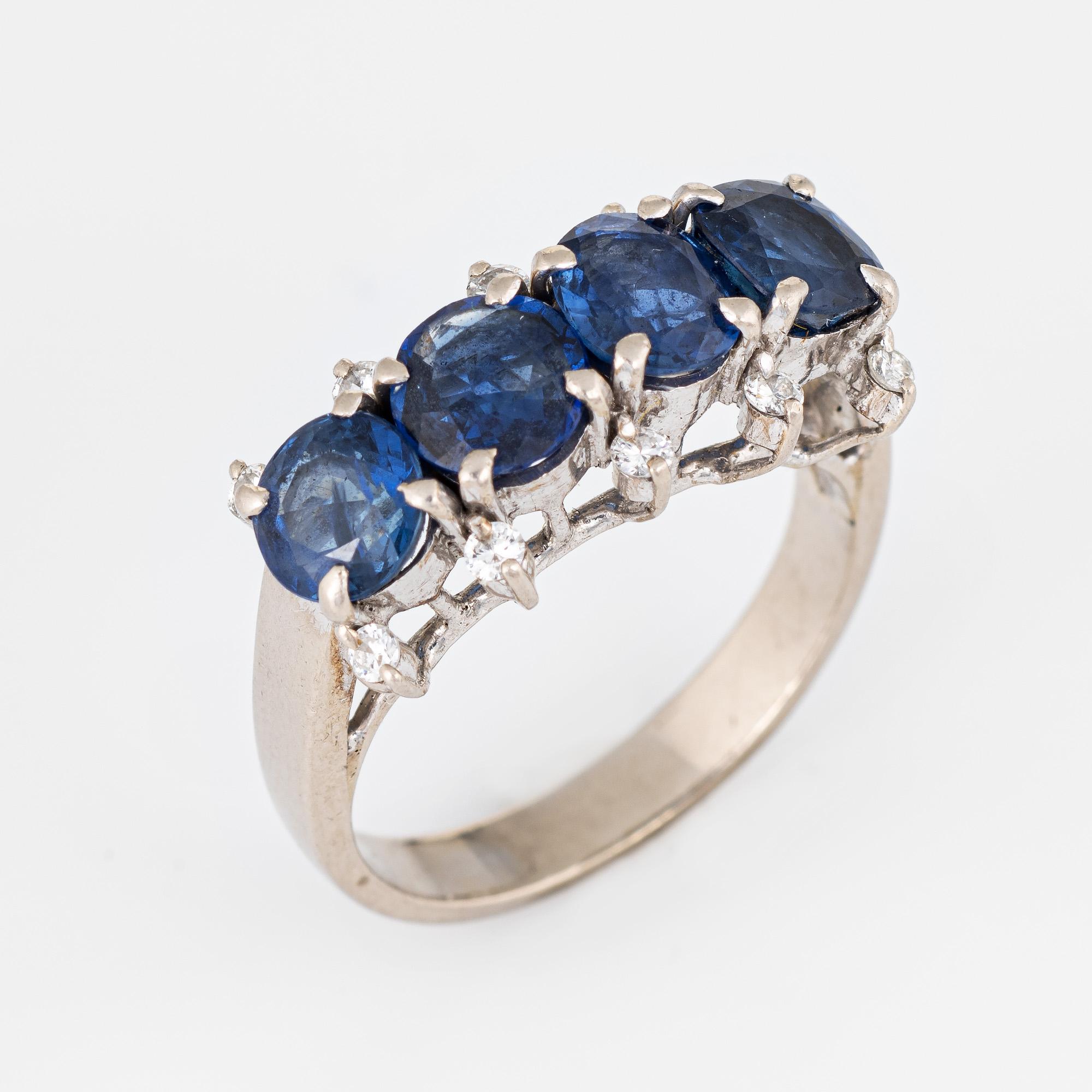 Stylish vintage sapphire & diamond anniversary ring (circa 1950s to 1960s) crafted in 14 karat white gold. 

Round cut blue sapphires are estimated at 0.70 carats each and total an estimated 3.50 carats. Ten round brilliant cut diamonds total an