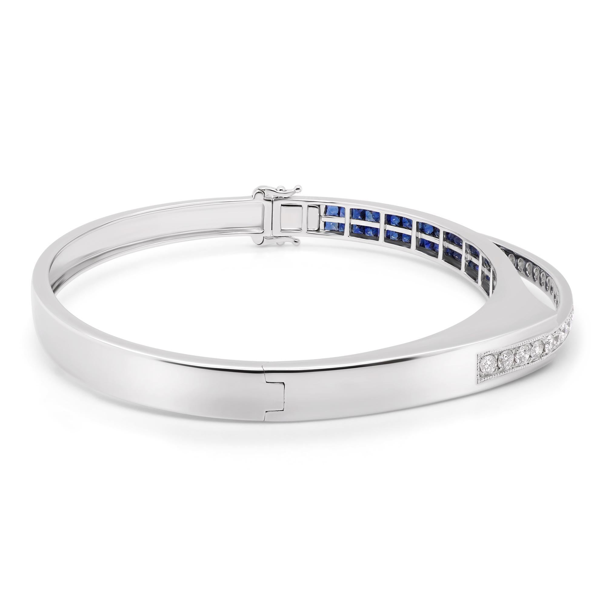 3.38 carats of vivid blue sapphire and 0.68 carats of white brilliant round diamond are set in a 18K bangle hand made in Japan. The details of the diamond are mentioned below:

Color: F

Clarity: VS
