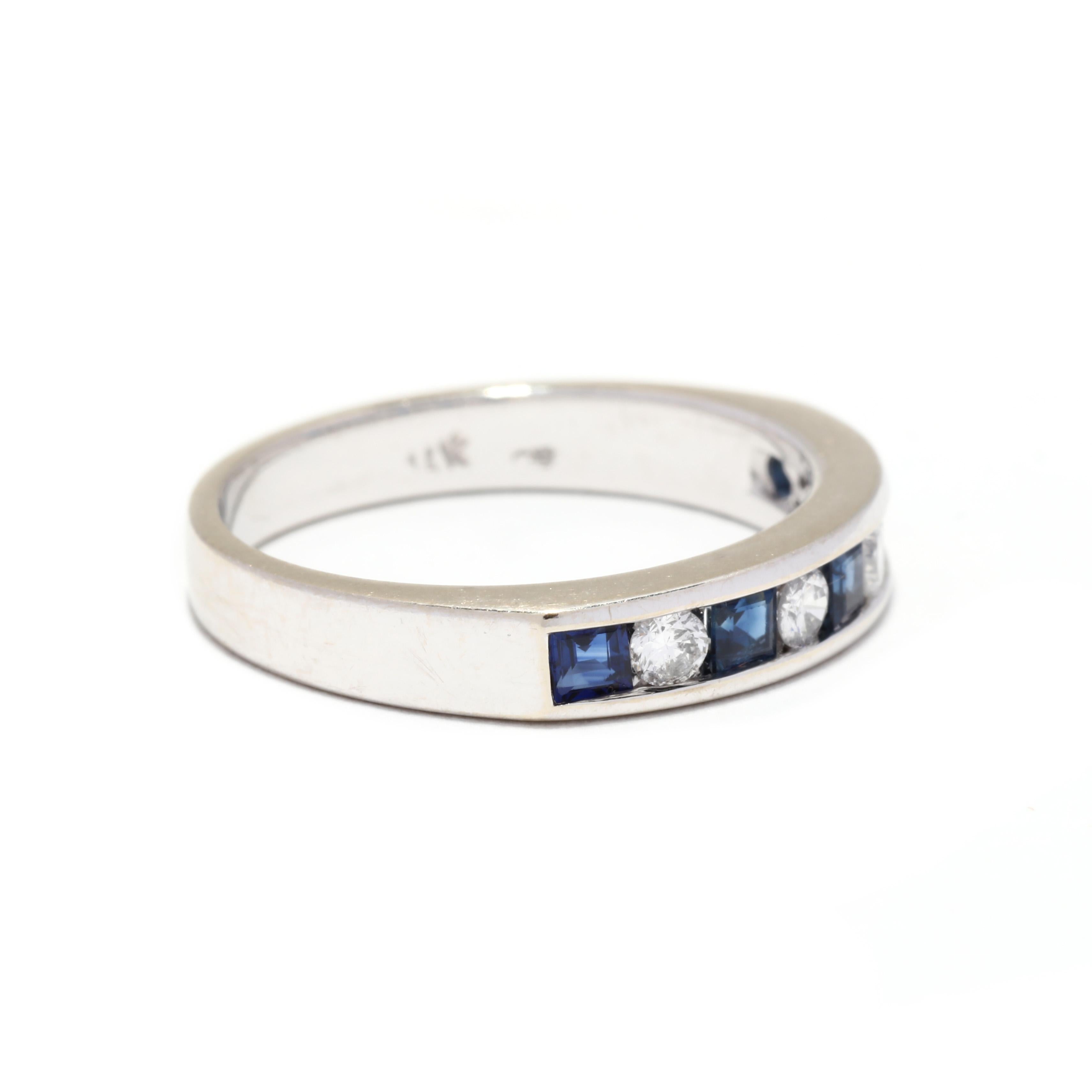 A vintage 14 karat white gold sapphire and diamond band. This stackable band features channel set alternating full cut round diamonds weighing approximately .16 total carats and square cut bright blue sapphires weighing approximately .45 total