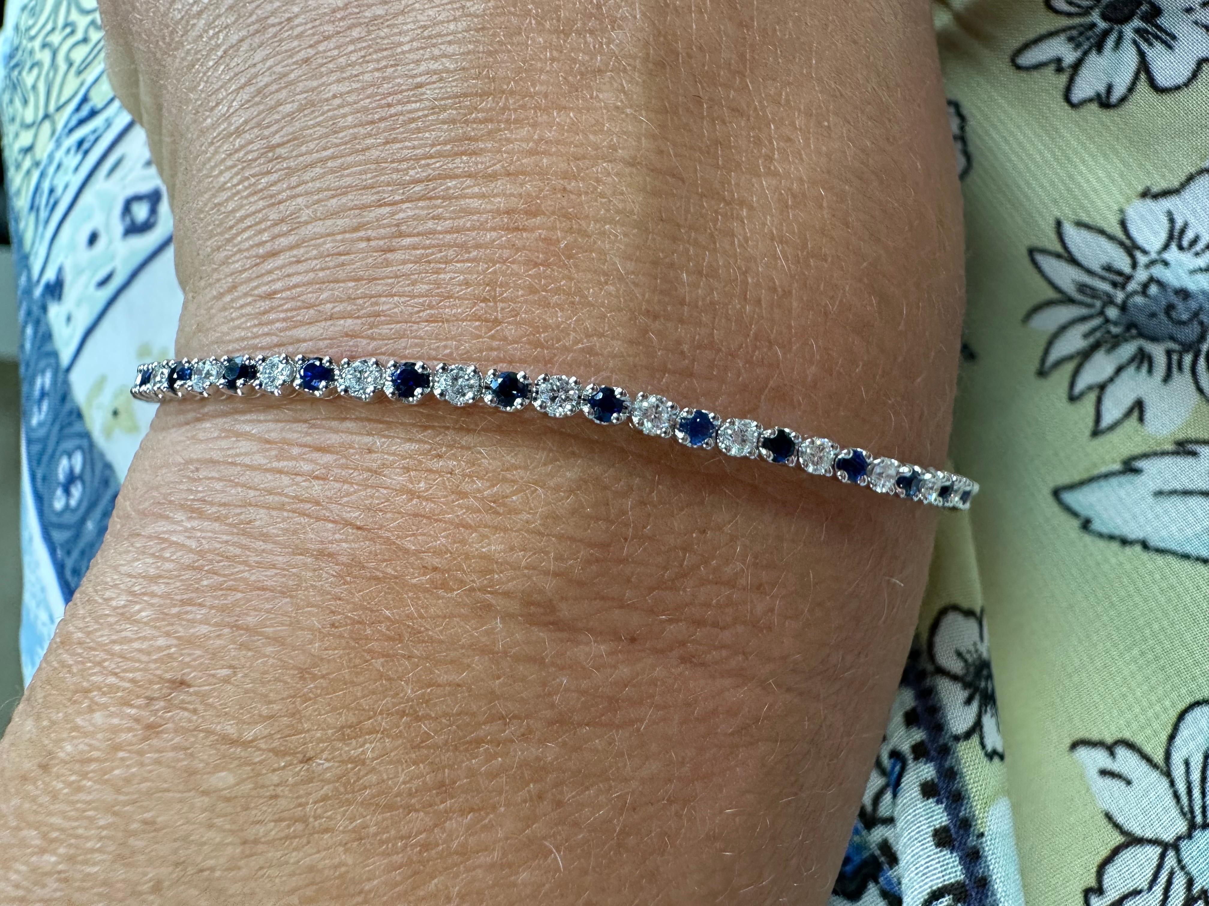 Stunning elegant diamond and sapphire bracelet in 14KT white gold. Tennis bracelet that looks good with anything!

GOLD: 14KT gold
NATURAL DIAMOND(S)
Clarity/Color: VS/G
Carat:1.23ct
NATURAL SAPPHIRE(S)
Clarity/Color: Slightly