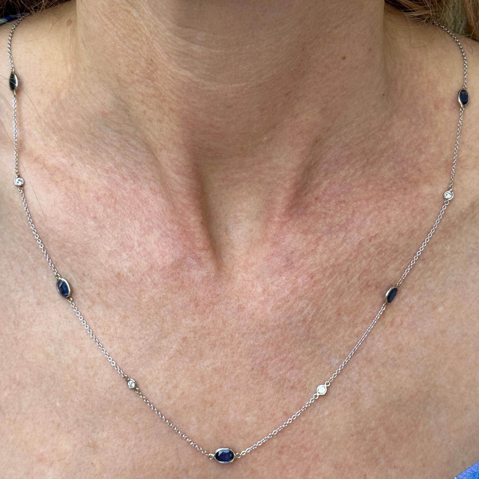 Modern sapphire and diamond By The Yard necklace crafted in 14 karat white gold. The necklace features 7 round brilliant cut diamonds weighing approximately .42 CTW and 8 oval blue sapphires weighing approximately 5.00 CTW. The diamonds are graded