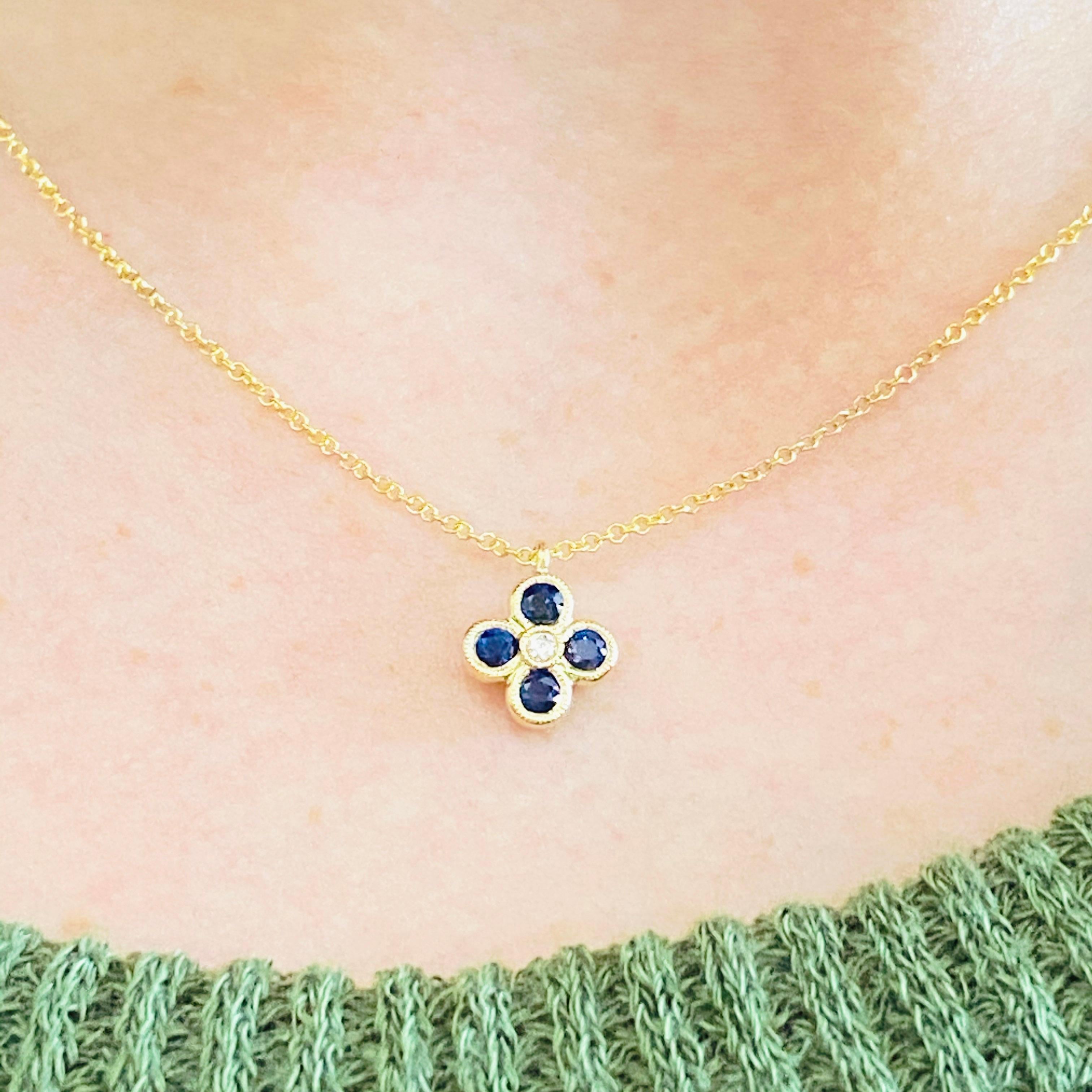 This Gabriel & Co. pendant is stunningly beautiful and has a blue sapphire quartet set in polished 14k yellow gold encircling a bright diamond is very modern yet classic! This necklace is classy enough to pair easily with formal wear, yet is very