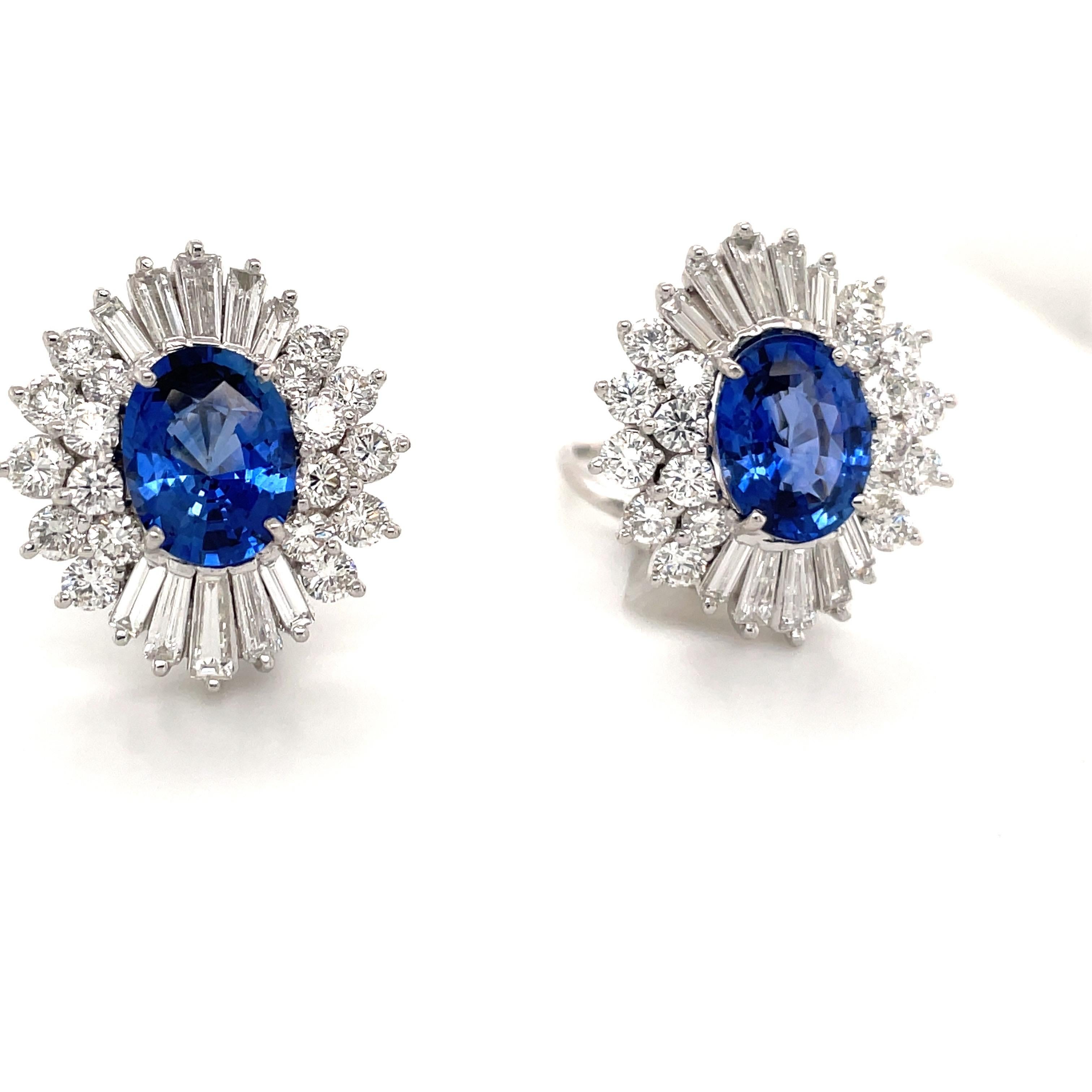 Impressive stud earrings featuring two oval shape blue Sapphires weighing 6.66 carats flanked with a cluster of round brilliants and tapered baguettes weighing 6 carats.
Color G-H
Clarity VS-SI

Gorgeous Sapphire color.
Can add post. 