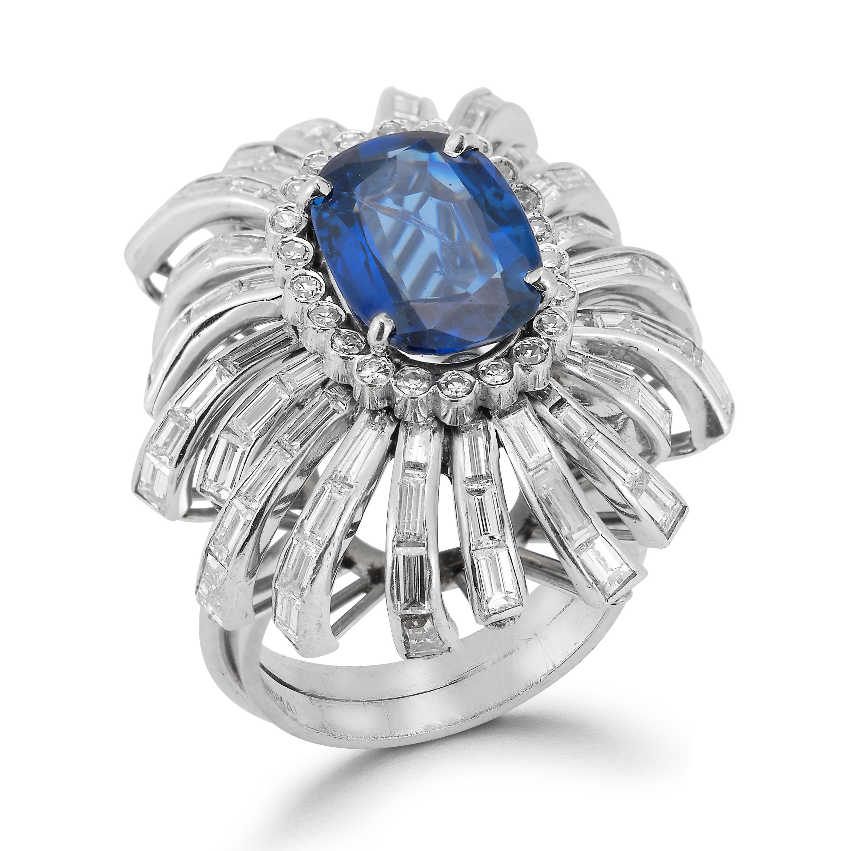  Sapphire & Diamond Cocktail Ring, A platinum and white gold ring set with a central oval sapphire with a halo of round diamonds and 21 rows of baguette diamonds extending outward

Sapphire approximate weight: 4.18

Diamonds total approximate