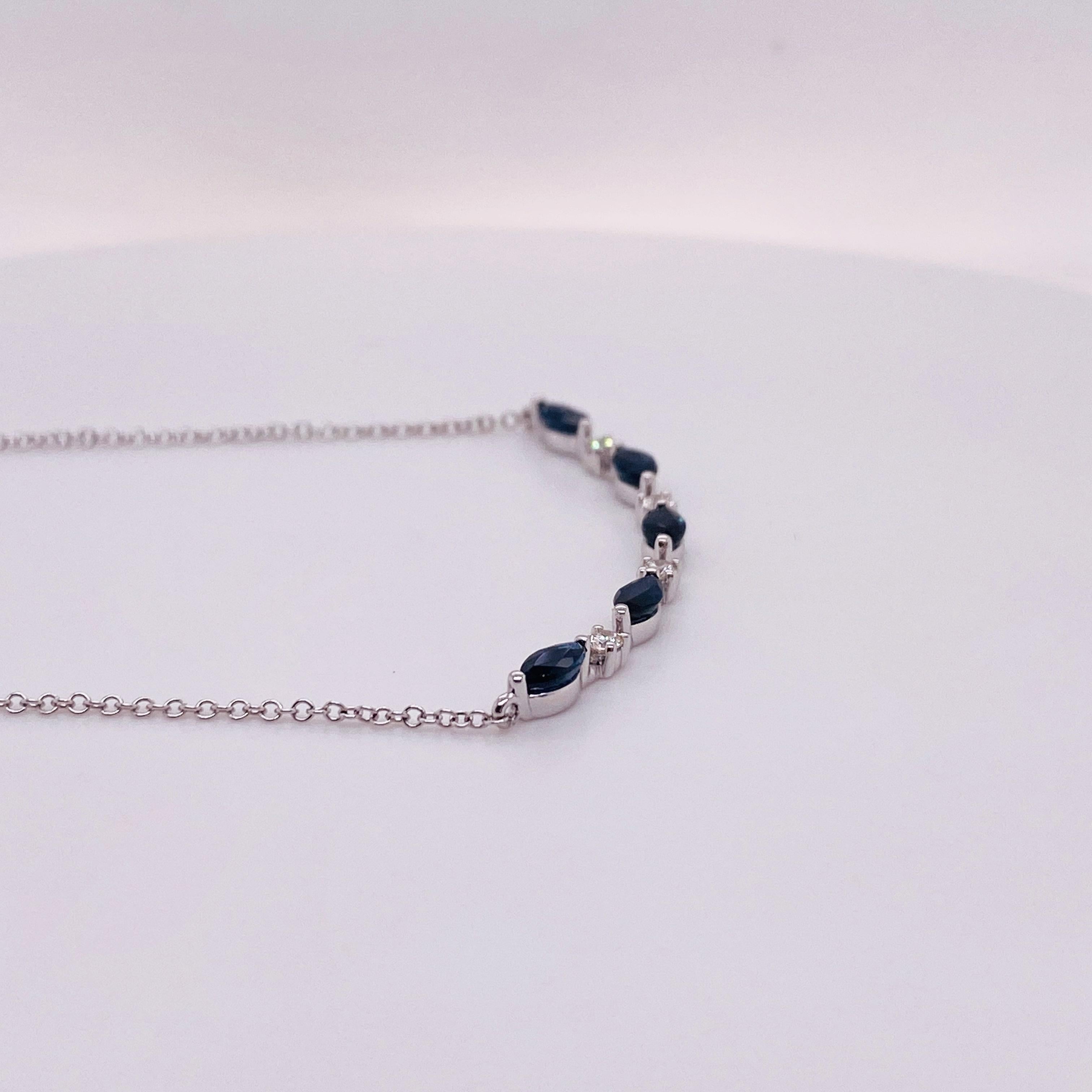 Grace your loved one's neck with this perfect sapphire and diamond necklace! The gracefully curving bar looks great alone or stacked with other favorite chains. Sapphires are September's birthstone and this could make a fabulous gift to your loved