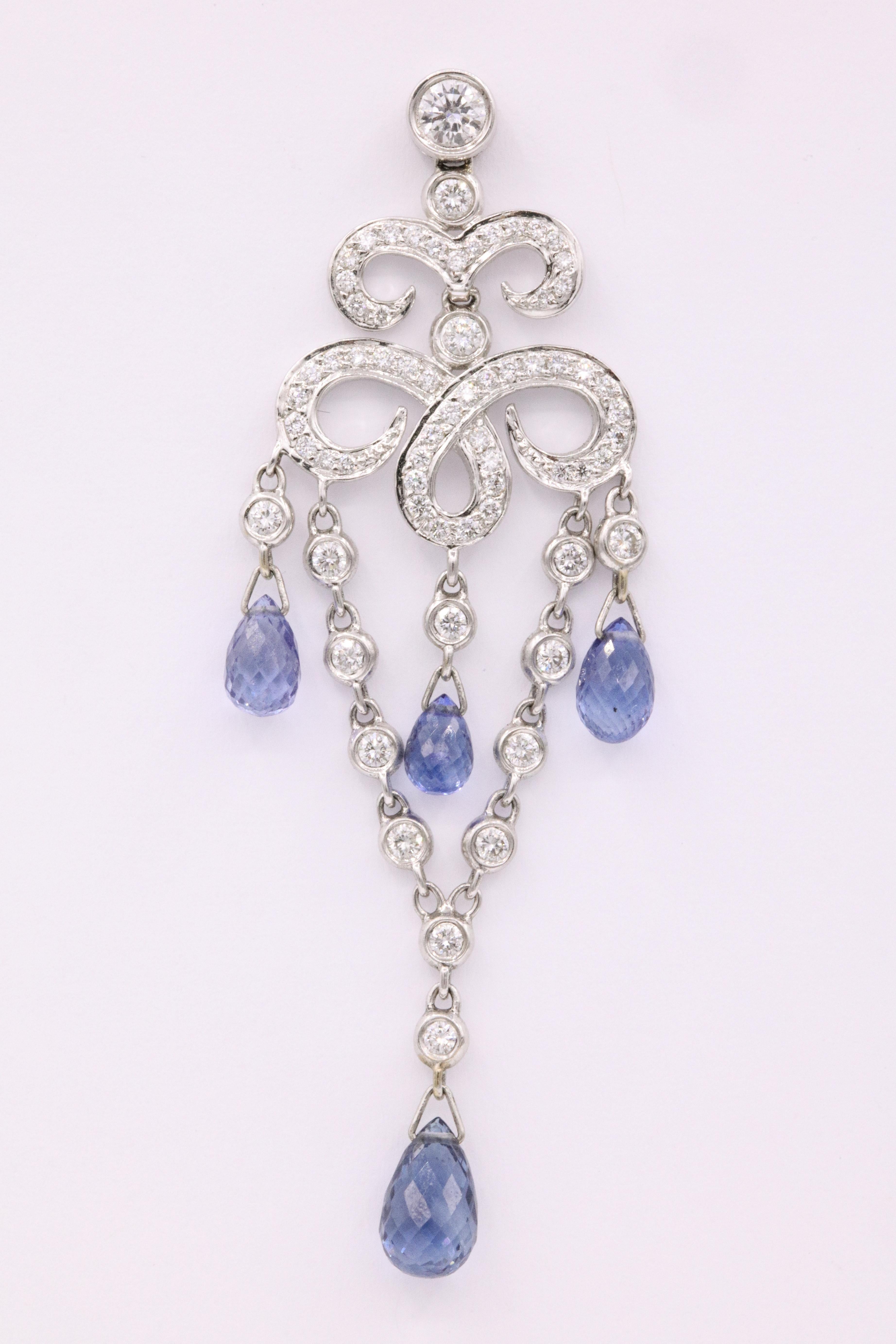 18K White gold drop earrings featuring 134 round brilliants weighing 1.28 carats and 8 blue sapphires weighing 6.43 carats.
Color G-H
Clarity VS-SI