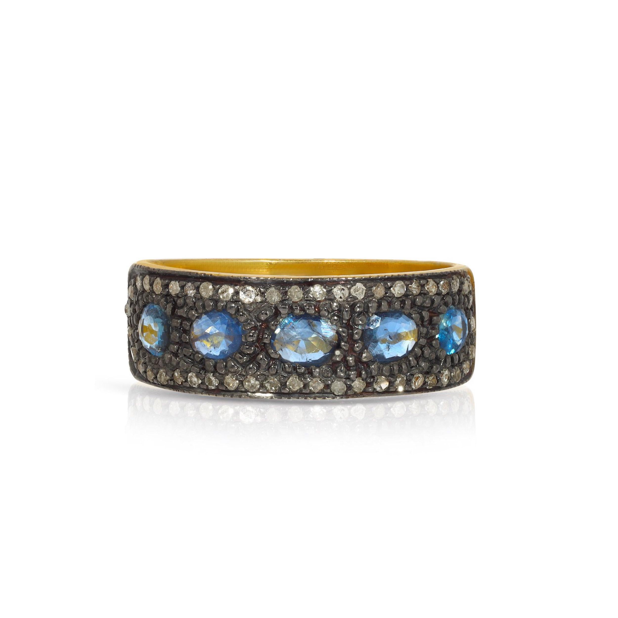 A beautiful Jaipur Mogul style band with a mix of gemstones and metals. This gorgeous ring features 1.65 Carats of stunning purple-blue Sapphires demi set in Blackened Oxidized Silver accented with .35 Carats of sparkling White Diamonds on a 22