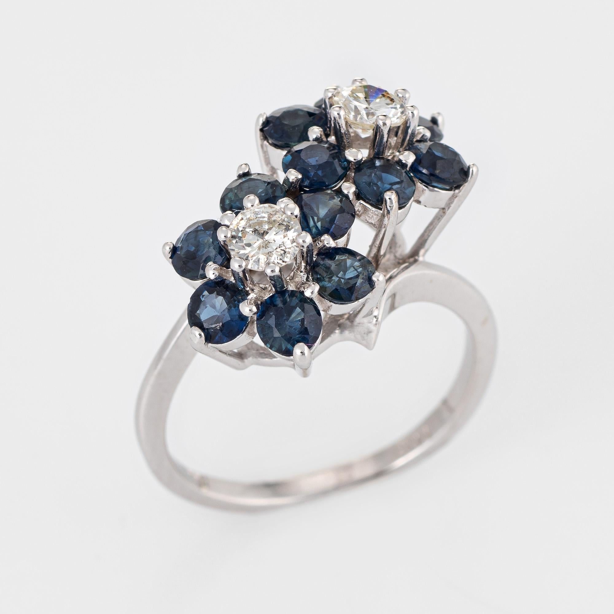 Finely detailed vintage sapphire & diamond double flower ring crafted in 14k white gold. 

Two estimated 0.20 carat (each) round brilliant cut diamonds total an estimated 0.40 carats (estimated at H-I color and SI2 clarity). 12 sapphires are