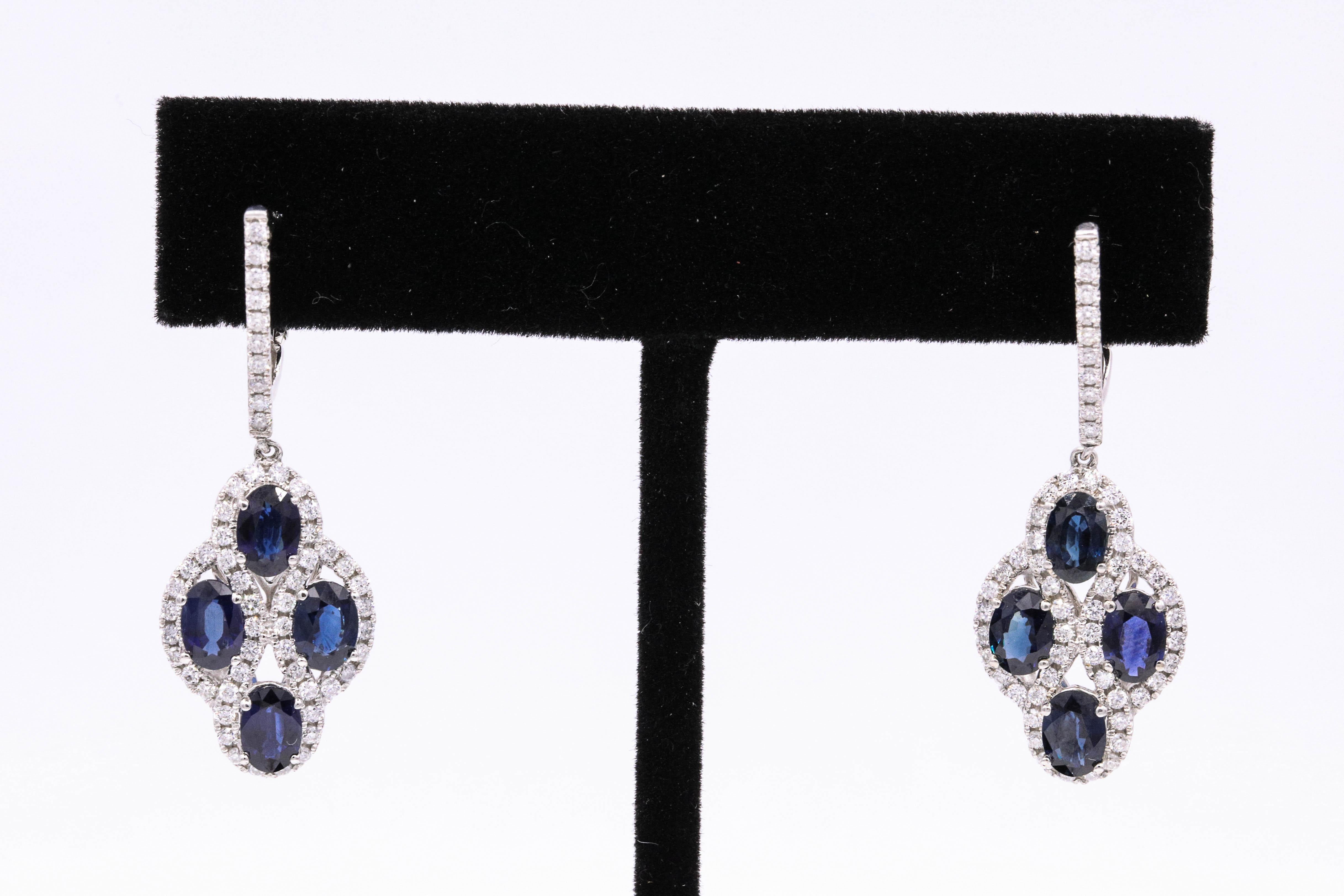 14K White gold earrings featuring four oval shape blue sapphires, 4.96 carats surrounded by round brilliants weighing 1.04 carats.
Color G-H
Clarity SI
