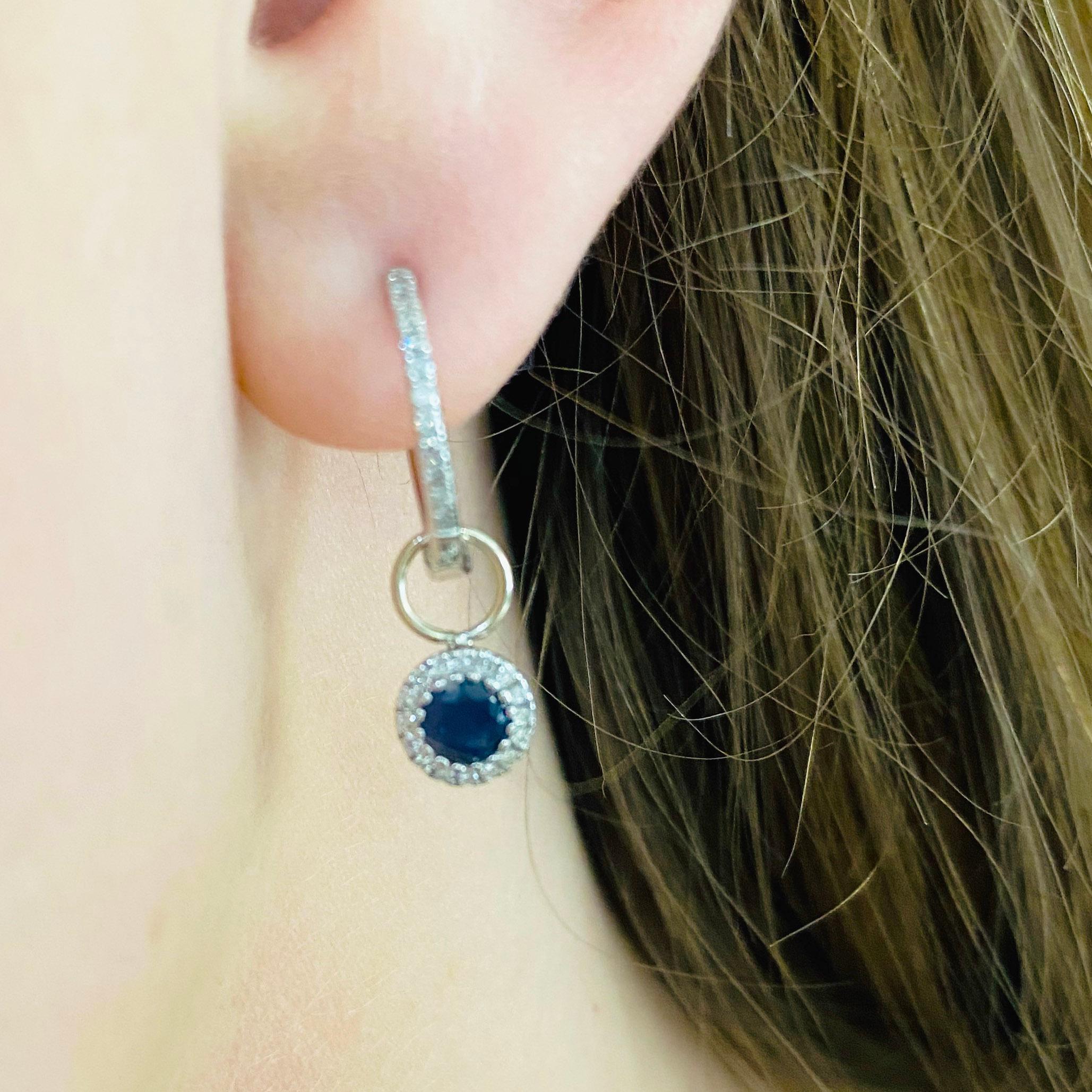 These stunning earring charms are the perfect way to dress up any pair of hoops! With polished 14k white gold surrounding a brilliant round blue sapphire and dripping with white diamonds, these charms make the perfect chic and modern accessory for