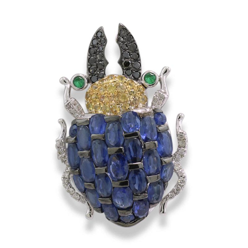 A jewel for true individualist and nature lovers: pendant made of precious gemstones in the shape of a Stag beetle, with its slightly curved back. It is adorned with oval-cut faceted blue sapphires, displaying a deep transparent blue, and 46 yellow