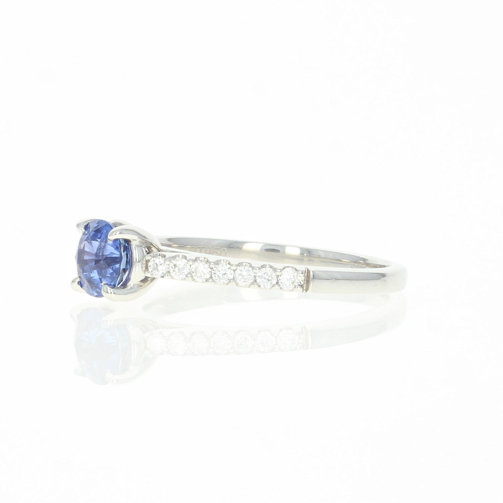 Captivatingly beautiful, this unique engagement piece will be a wonderful choice for your bride-to-be! This ring is crafted in heirloom-quality 950 platinum and showcases a vivacious sapphire solitaire sweetly accompanied by glittering white