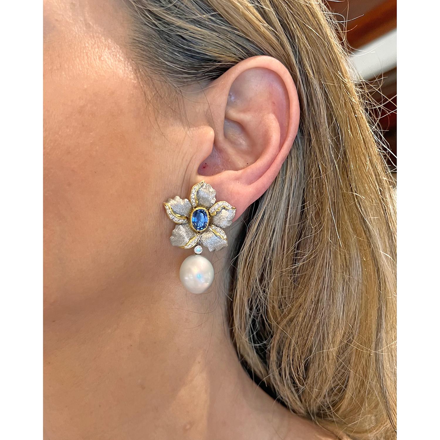 Flower earrings in brushed 18k white gold, each centering a larger oval-shaped sapphire bezel-set in 18k yellow gold with round brilliant-cut diamond accents and suspending a removable pearl drop with round brilliant-cut diamond surmount.  Two