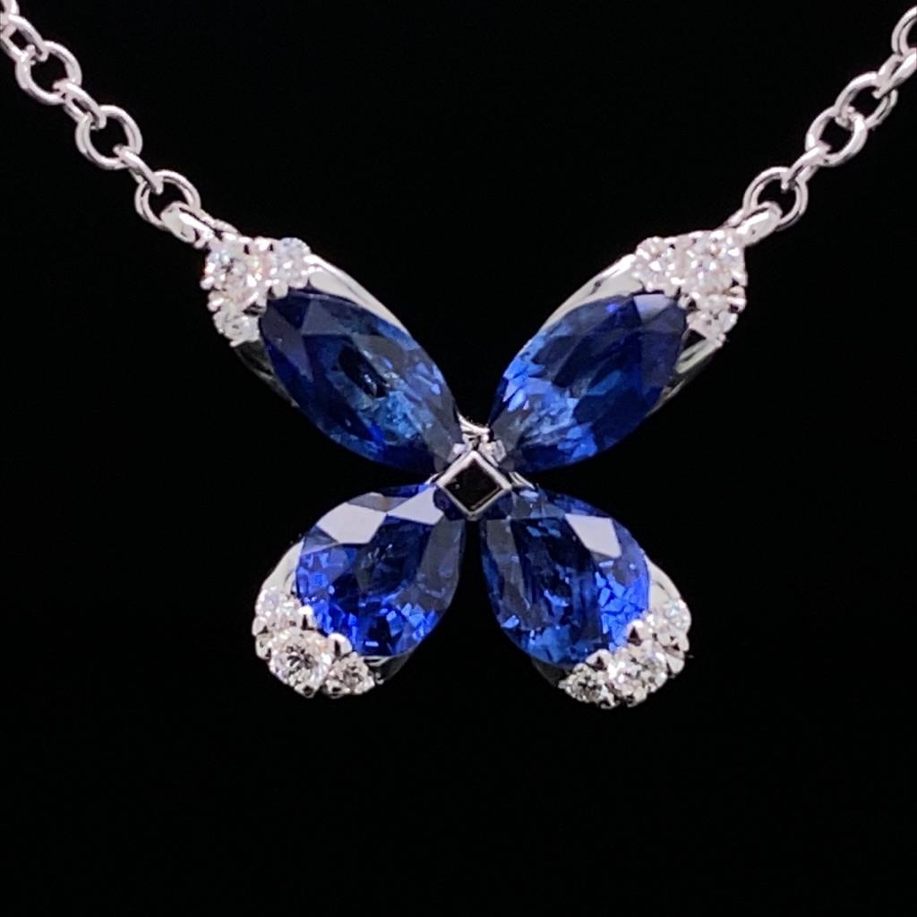 A sapphire diamond flower necklace in 18 karat white gold.

This beautiful pendant features two pear cut and two marquise cut sapphire petals of vibrant royal blue colour, each petal is tipped with three bright round brilliant cut diamonds. 

The