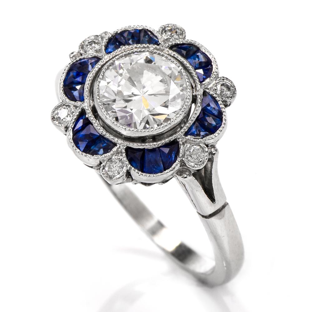 This whimsical sapphire and diamond flower engagement ring is crafted in solid platinum. Exposing a centered round brilliant cut diamond and 7 smaller diamond petals cumulatively weighing approx. 1.05 carats, graded H-I color, and SI clarity. The