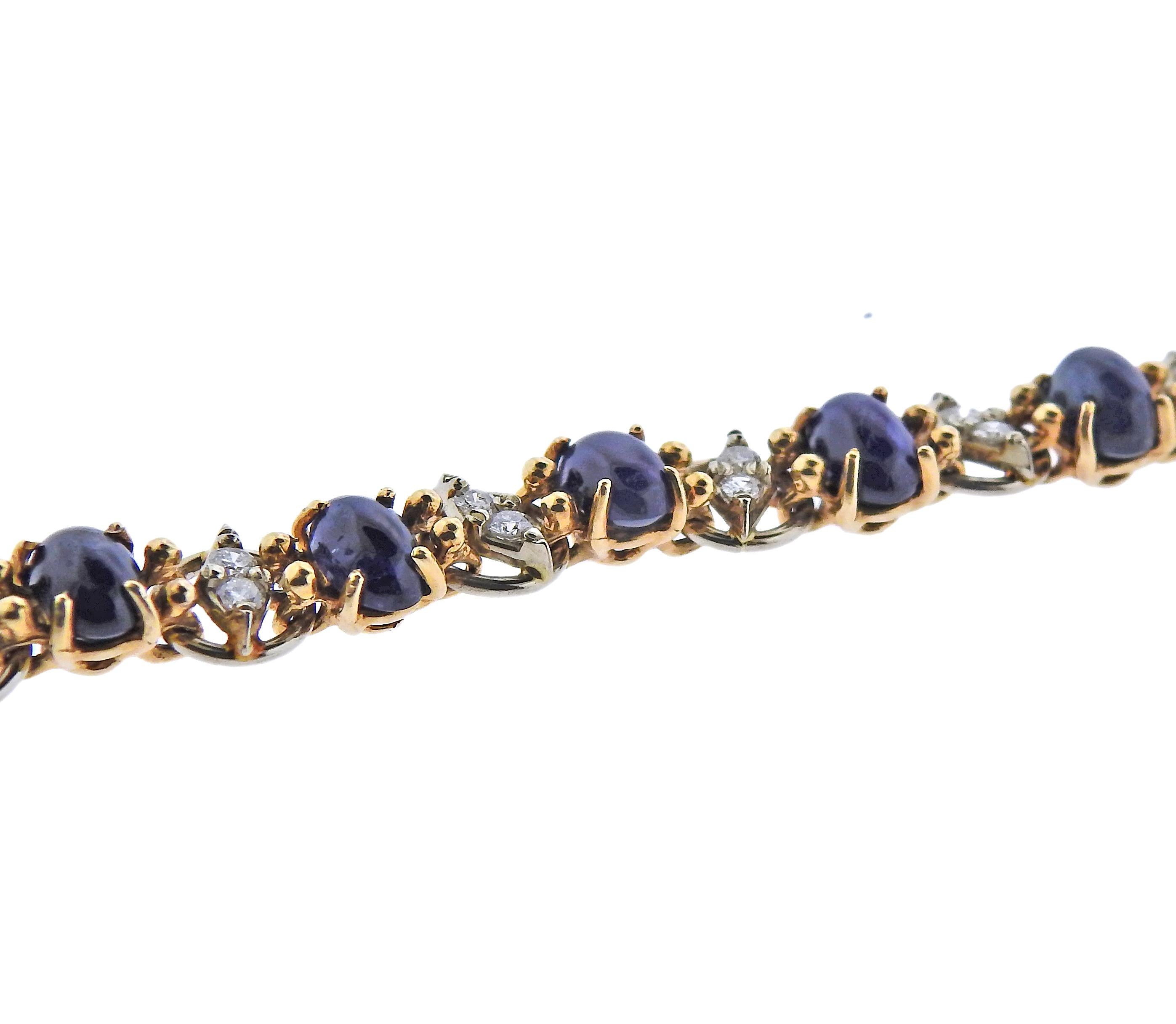 14k gold bracelet, set with blue sapphire cabochons and approx. 0.60ctw in diamonds. Bracelet is 7