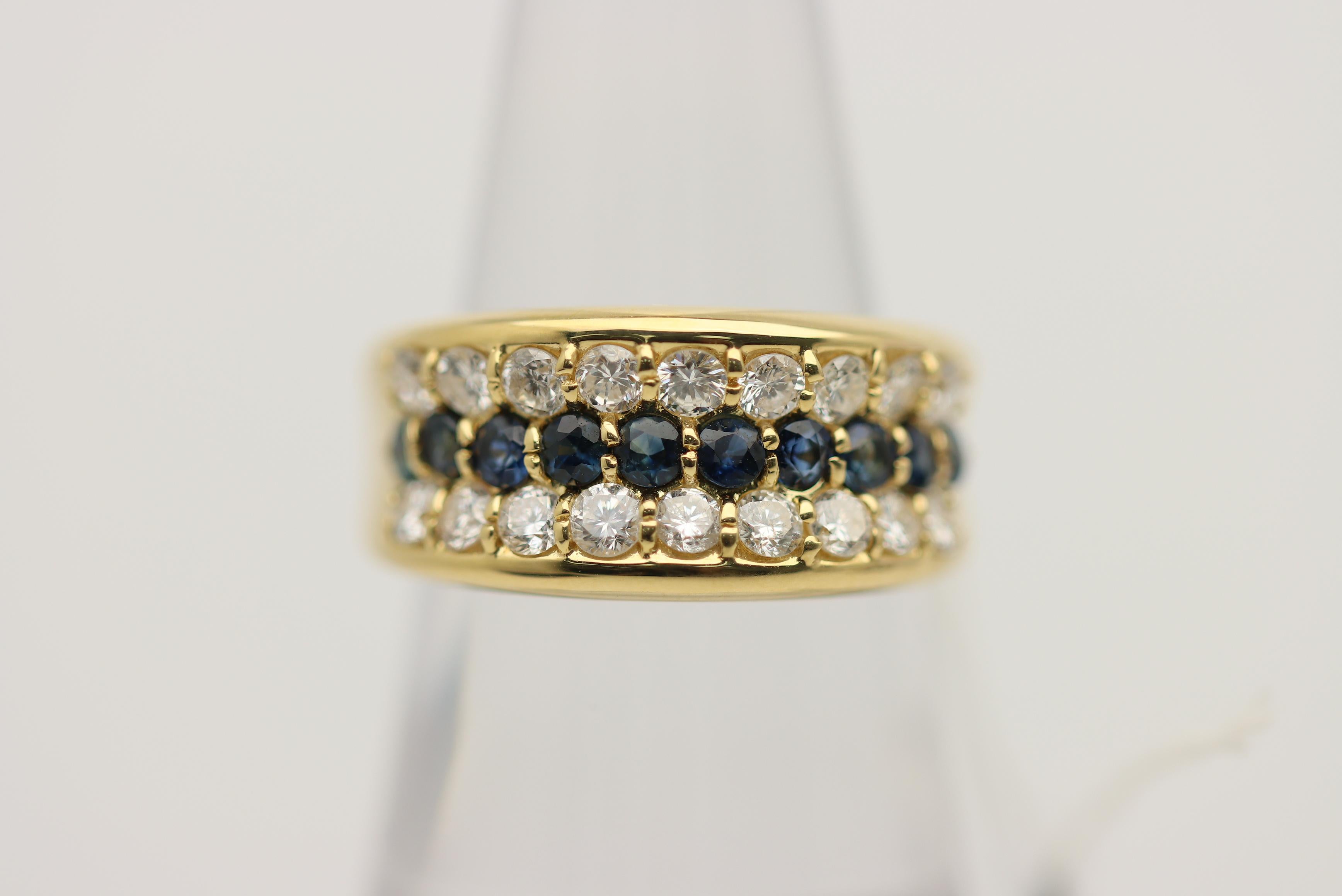 A lovely gold ring featuring a single row of sapphires set between two rows or diamonds. The sapphires weigh 0.78 carats of round blue sapphires while the diamonds weigh 1.06 carats. Made in 18k yellow gold and ready to be worn.

Ring Size