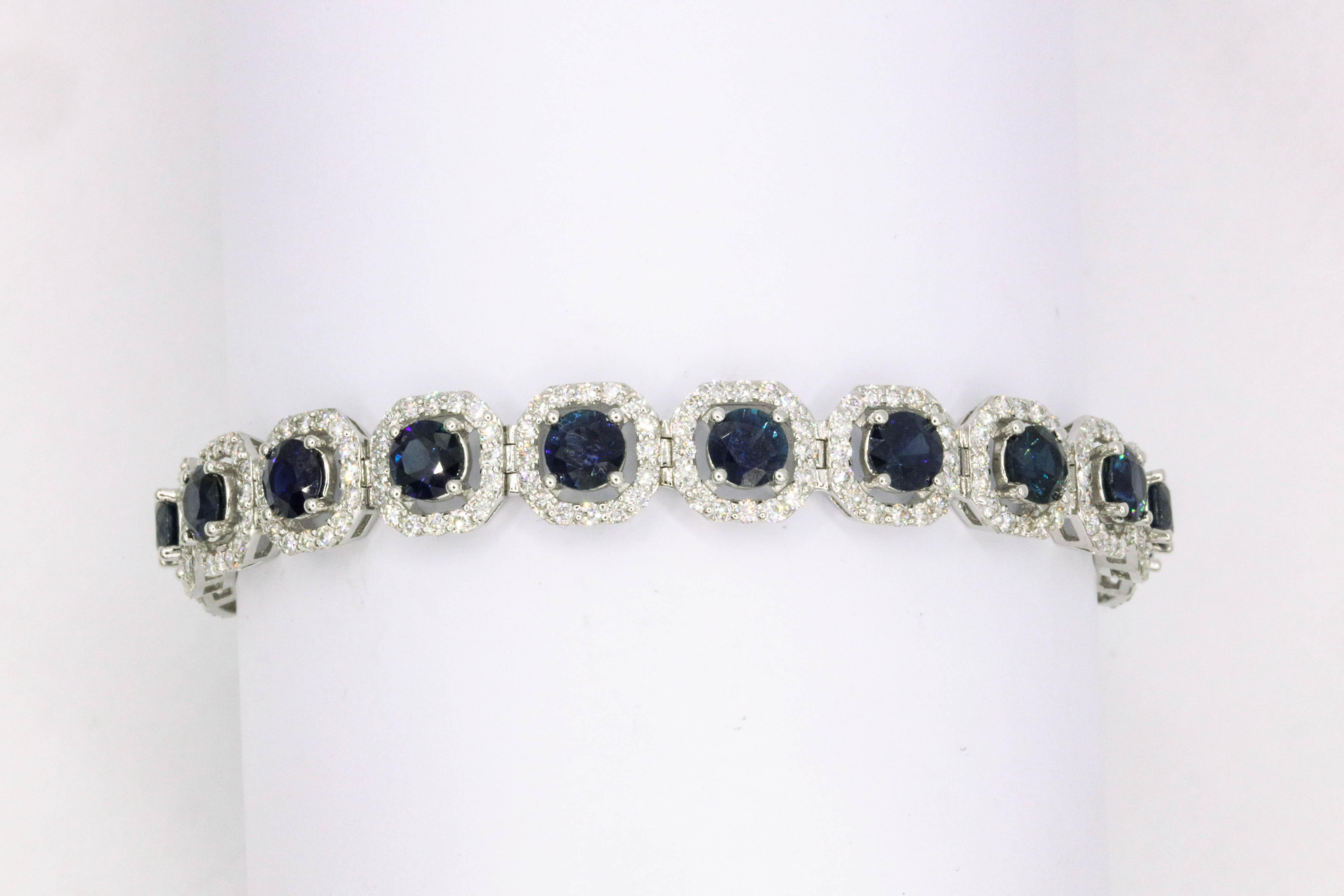 Nineteen round sapphires weighing 10.02 carats flanked with 304 round brilliants weighing 3.90 carats in 18k white gold. 