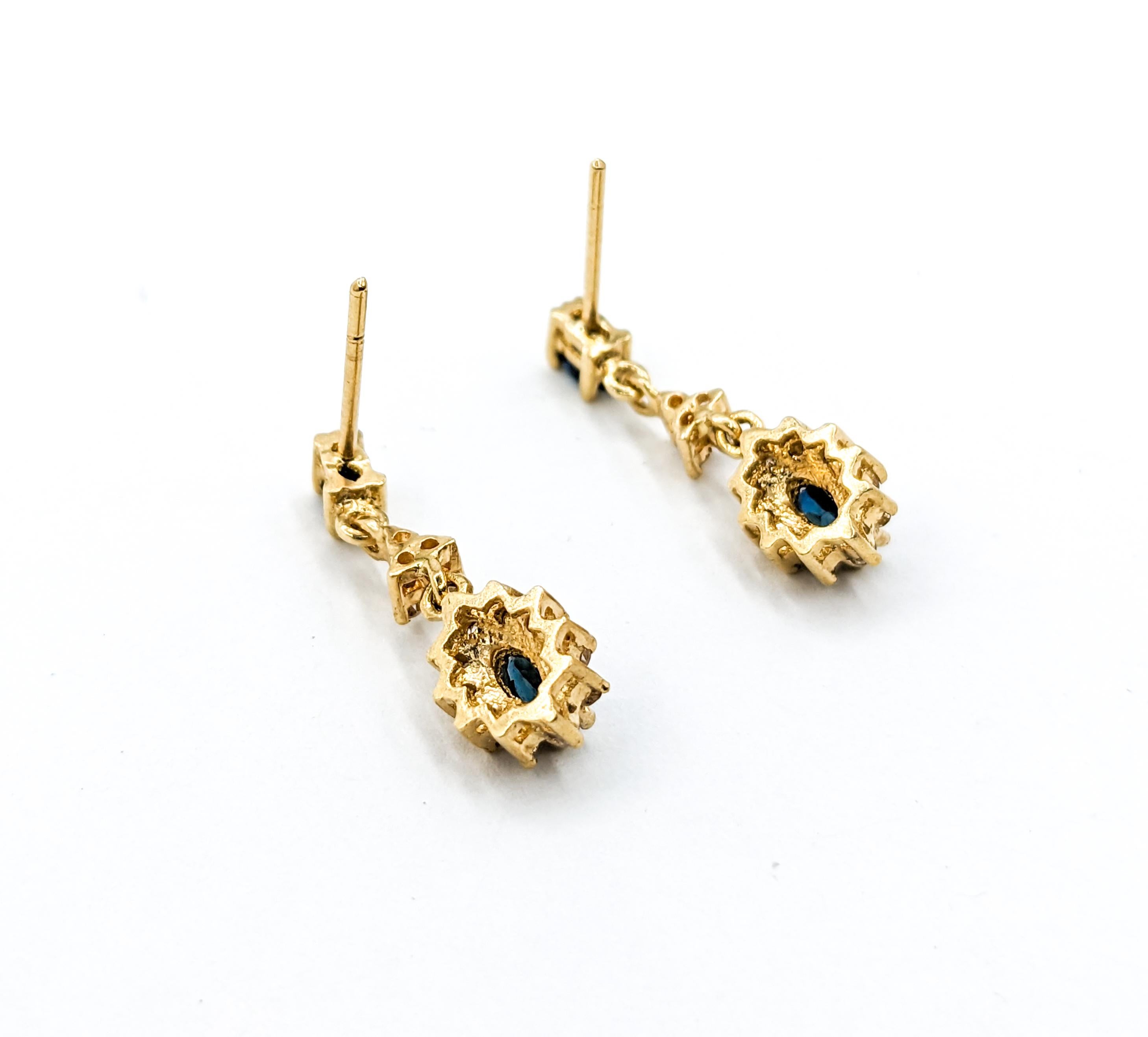Sapphire & Diamond Halo Dangle Stud Earrings in Yellow Gold

These elegant Sapphire Earrings are crafted in 14k Yellow Gold and feature a total of 0.20 carats of Single Cut Diamond accents. The diamonds boast I clarity and near colorless, white