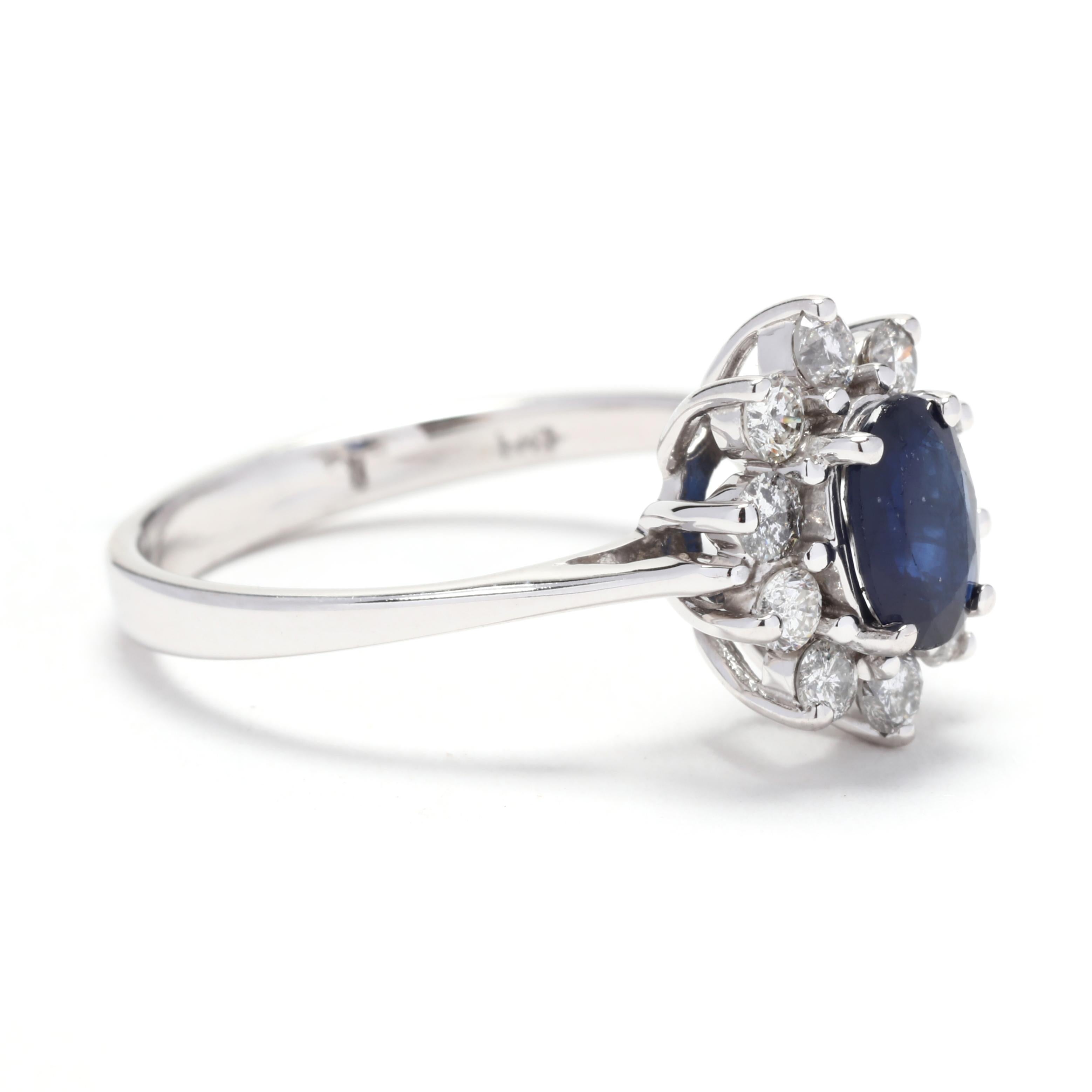 This stunning Oval Sapphire Diamond Halo Engagement Ring in 14K White Gold is a true statement piece. The centerpiece of this ring is a beautiful oval-cut sapphire, known for its deep and rich blue color. Surrounding the sapphire are sparkling
