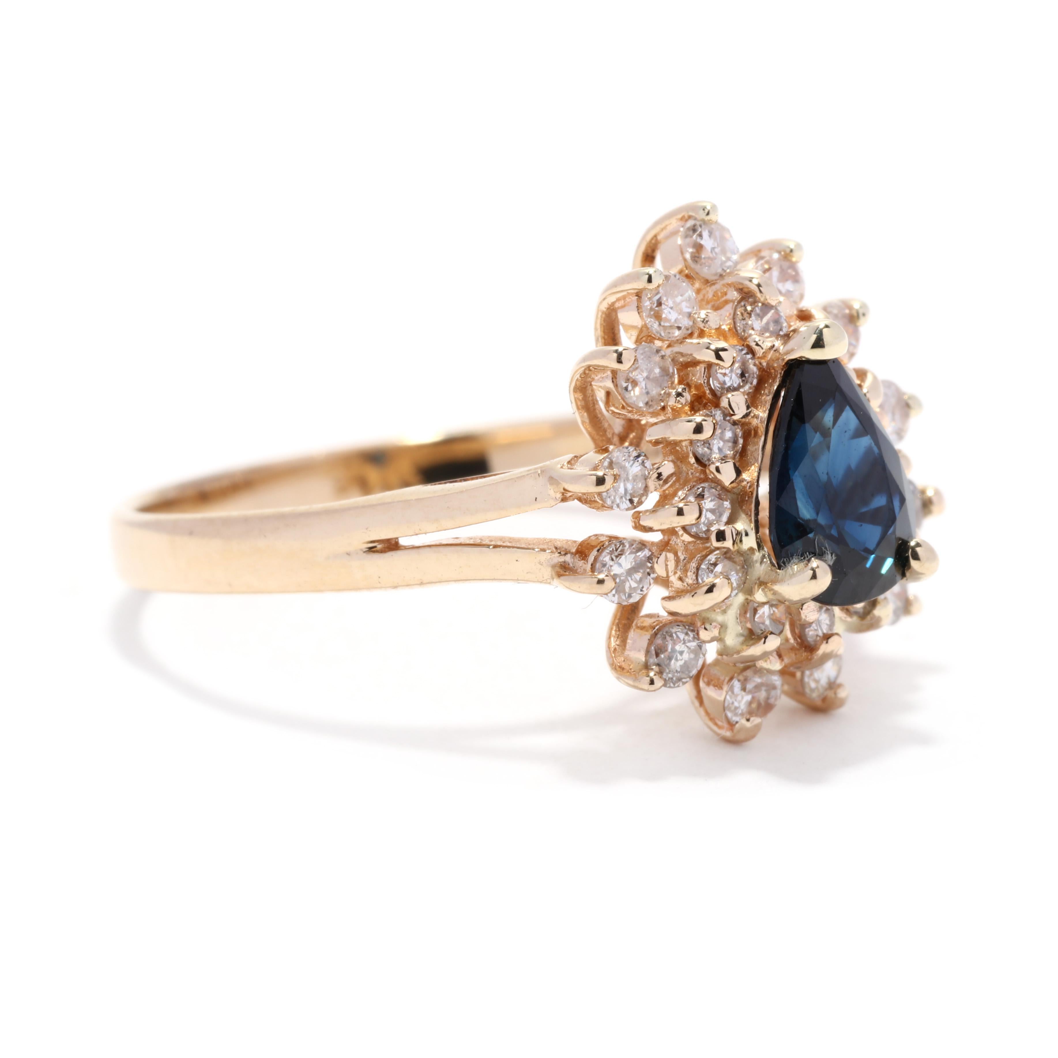 A vintage 14 karat yellow gold sapphire and diamond halo ring. This pear cut natural sapphire ring features a prong set, pear cut sapphire weighing approximately .85 carat surrounded by a double halo of round brilliant cut diamonds weighing
