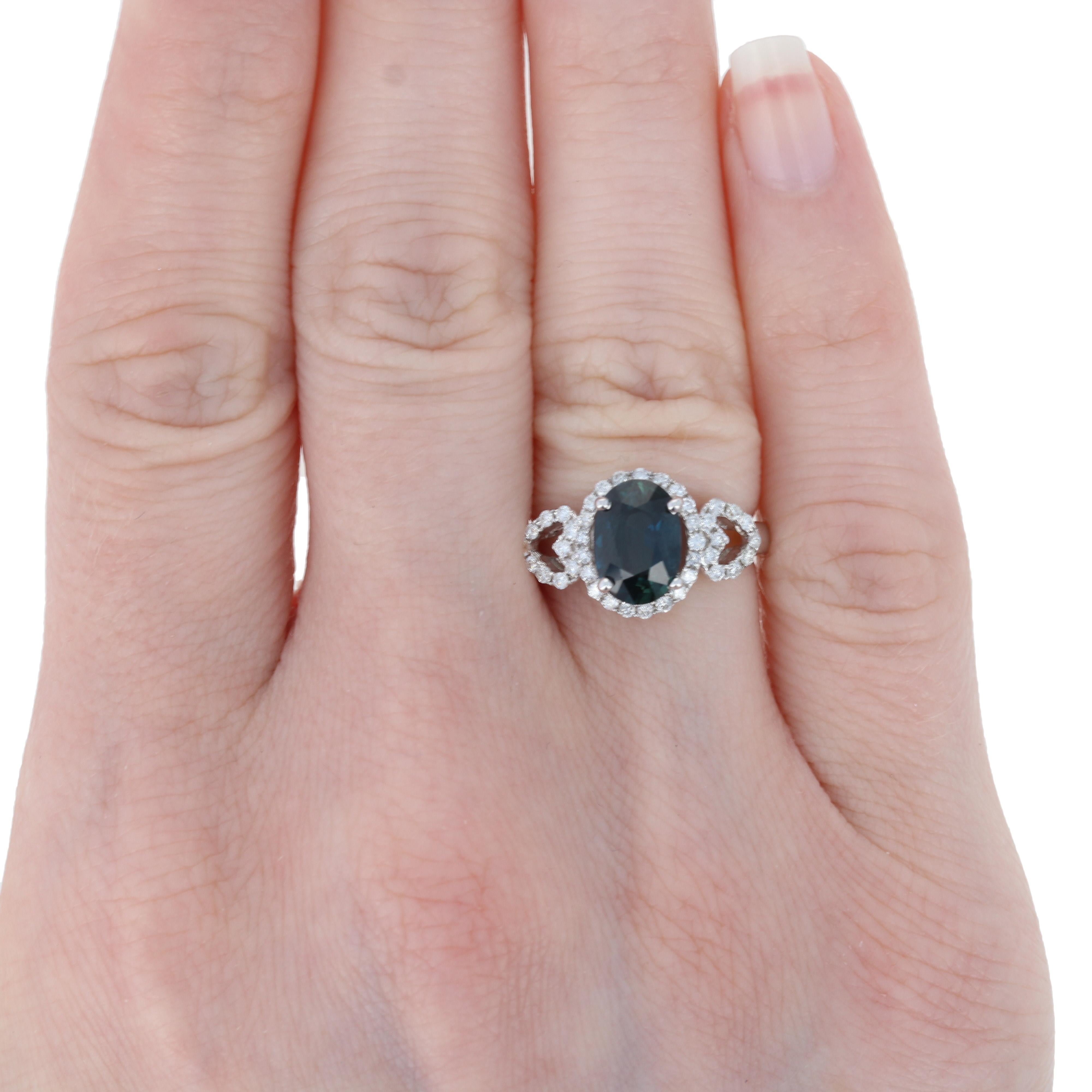 This resplendent sapphire and diamond ring is destined to become a signature piece in your jewelry collection cherished for many years to come! Crafted in luxurious 18k white gold, this ring showcases a 2.10 carat total weight genuine sapphire