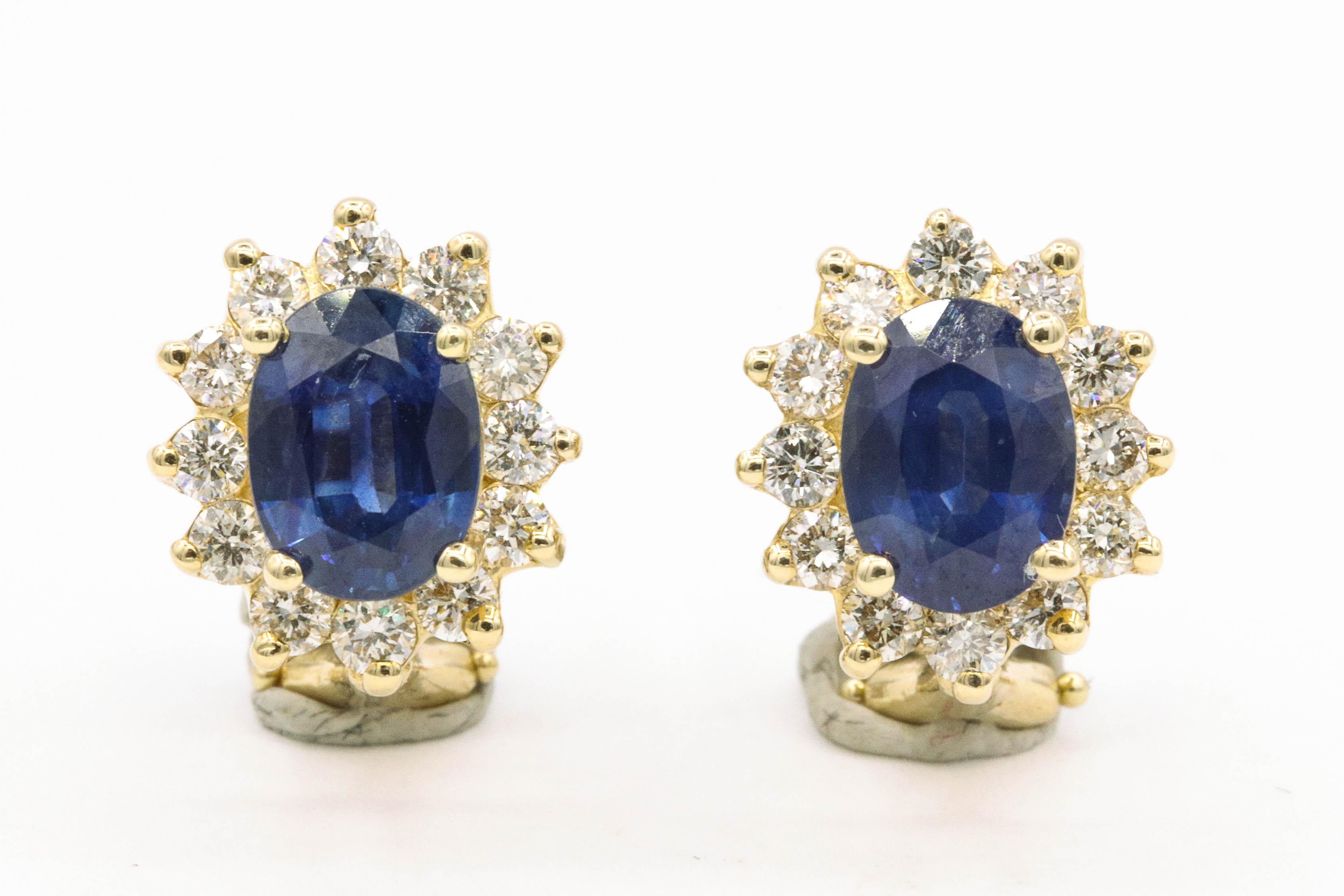 14K Yellow gold stud earrings featuring two oval shape blue sapphires, 3.20 carats flanked with round brilliants weighing 0.94 carats.
Color G-H
Clarity SI