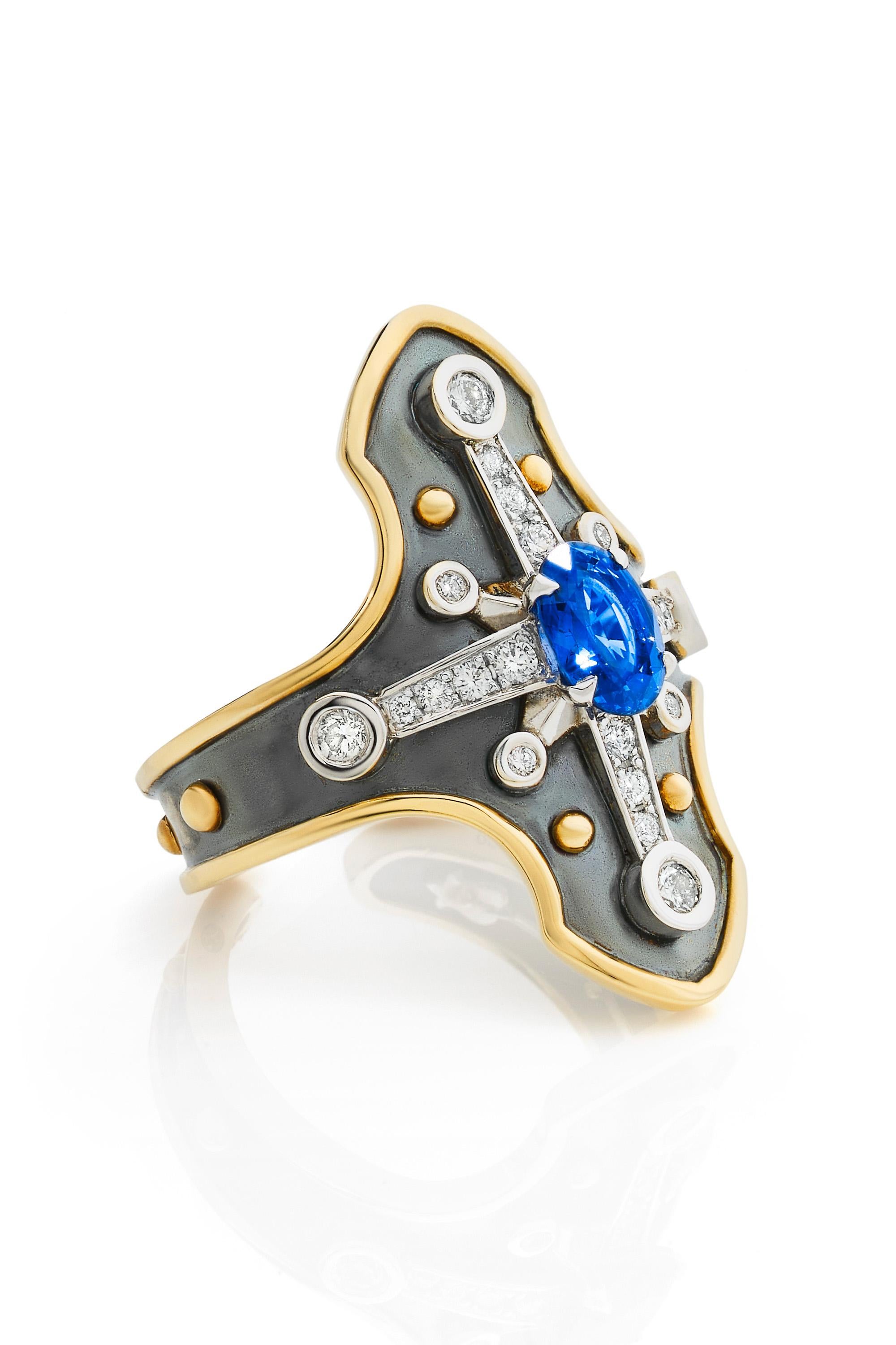 Yellow gold and distressed silver ring studded with an oval sapphire surrounded by diamonds set on a white gold star.

Details:
Sapphire: 7x5x 0,9 cts
22 Diamonds : 0.36 cts    
18k Gold: 4.5 g 
Distressed Silver: 3 g
Made in France