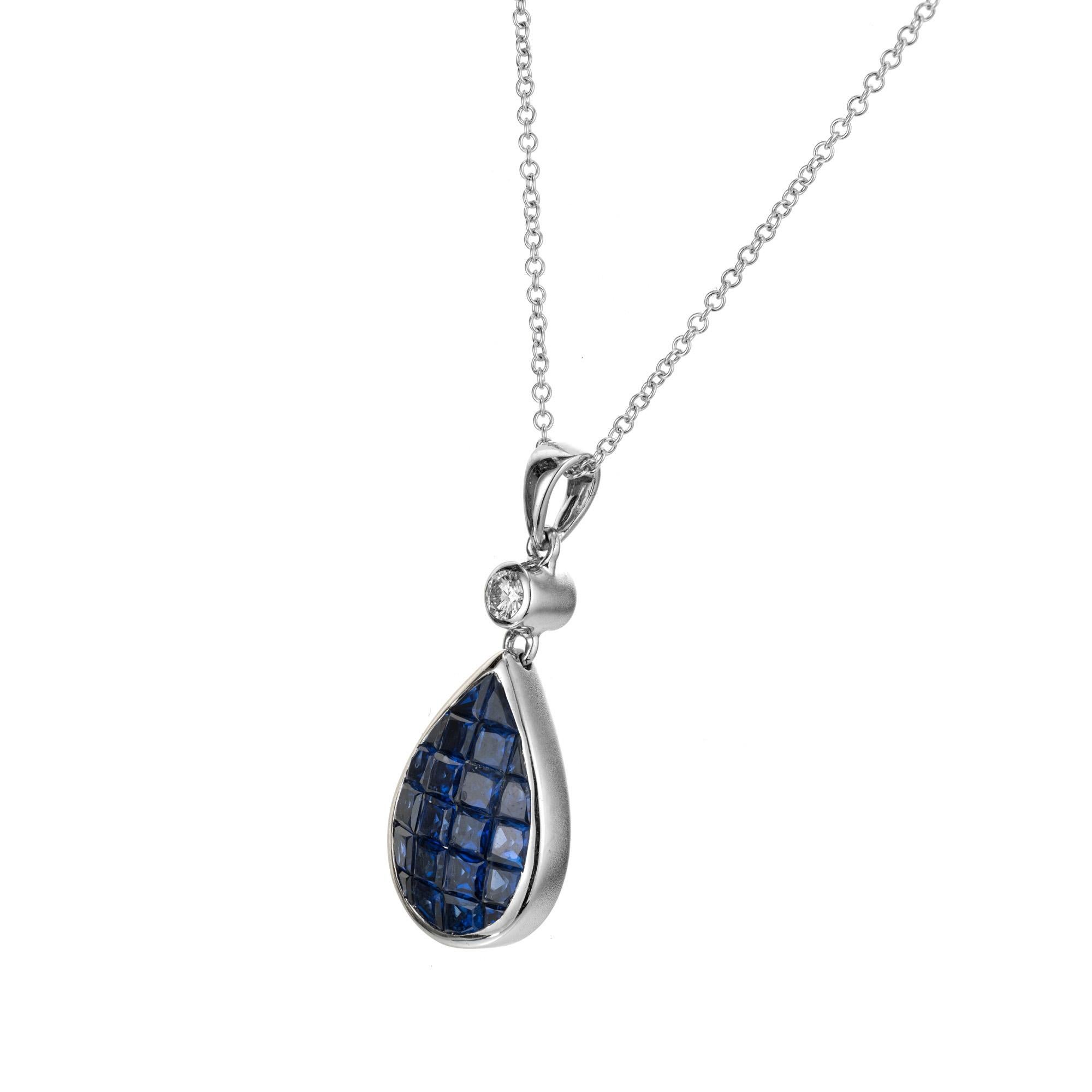 Sapphire and diamond pendant necklace. 22 calibre cut sapphires invisible set into a pear style 18k white gold bezel with one accent diamond on the bail. 16 inch 18k white gold chain.  The method of setting stones this way was invented by Van Clef