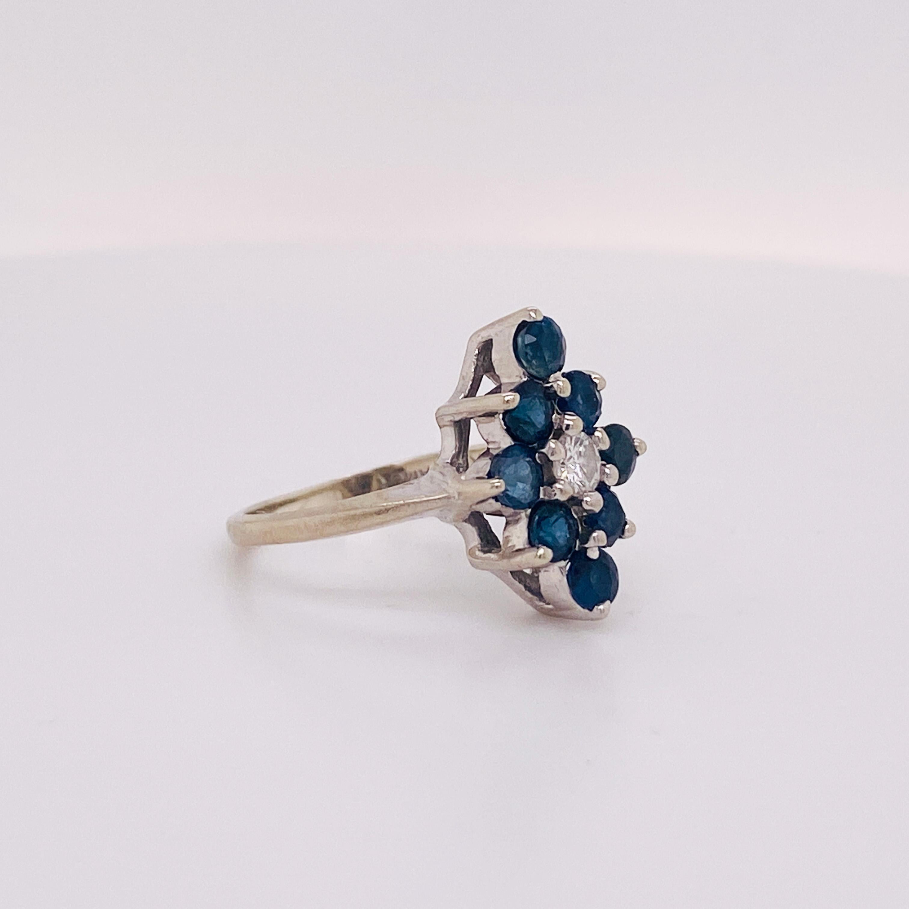 Made in bright 14 karat white gold, this beautiful cluster sapphire and diamond ring would make the perfect gift for a loved one or for yourself. Are you a blue queen of diamonds? The diamond shape around a center diamond is perfect for the card