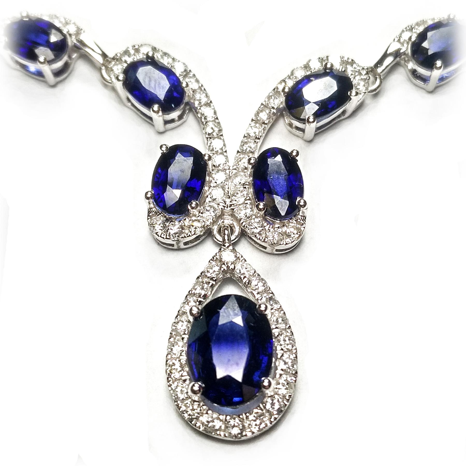 Sapphire 25.34 carats oval faceted natural deep blue-violatish tint, with diamond necklace. Handcrafted scalloped design with round brilliant cut diamonds, oval sapphires mounted in open basket, with 4 prongs, attached with pear shape dangling