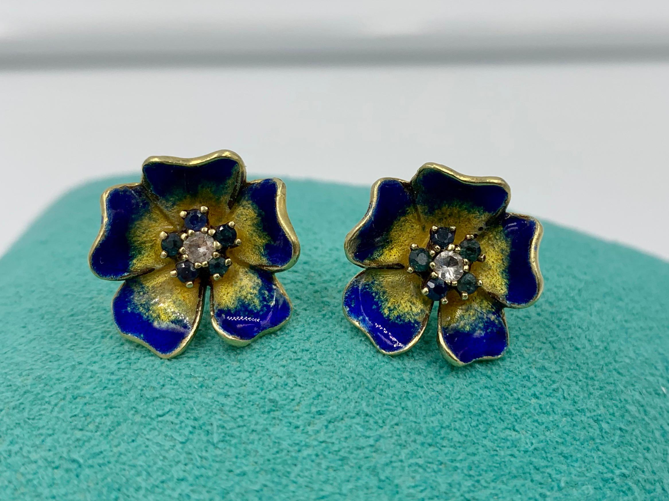 A gorgeous pair of Antique Pansy Flower Earrings with Diamond and Sapphire centers in beautifully modeled and enameled petals.  The earrings are 14 Karat Gold.  These beautiful flower earrings are so delicate and romantic and are just the perfect