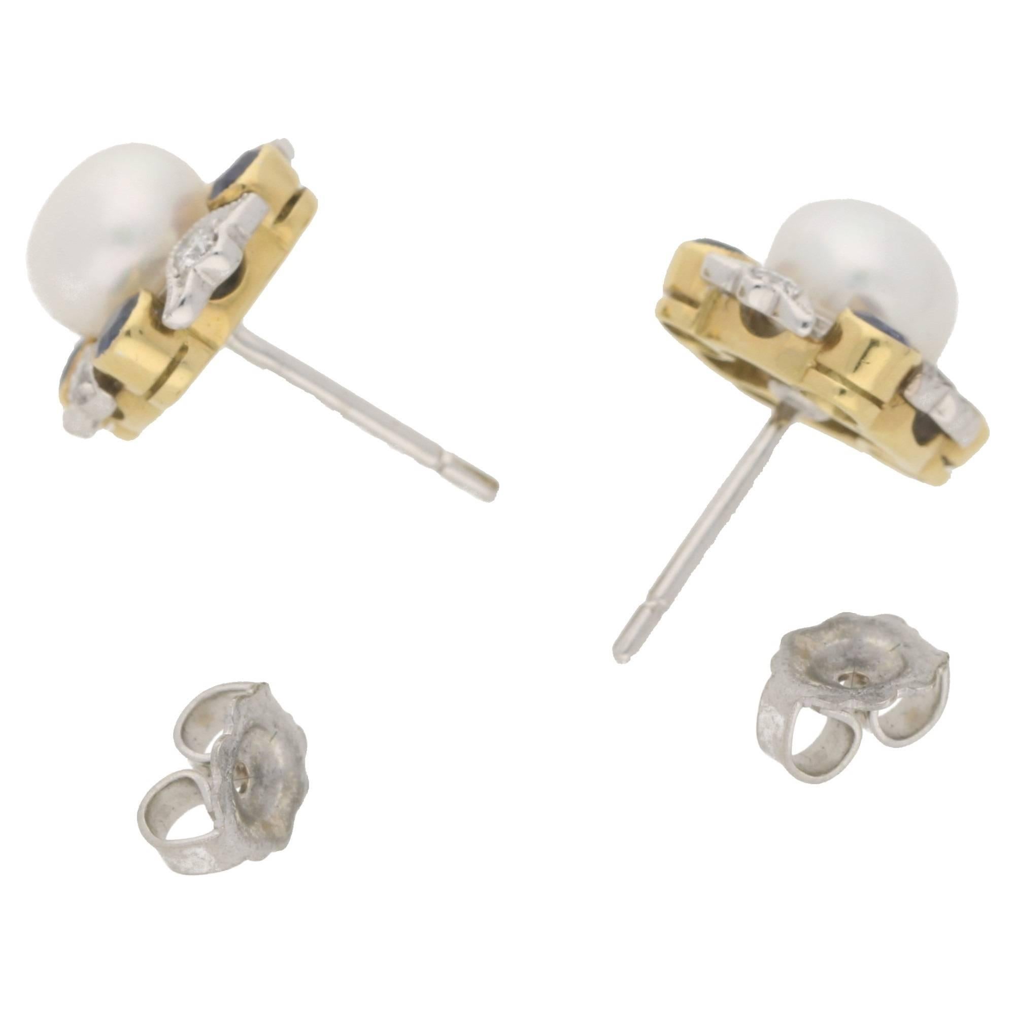 Pearl: 6.2mm. Estimated total sapphire weight: 0.64cts. Estimated total diamond weight: 0.24cts. Assessed diamond colour: H. Assessed diamond clarity: VS
A sublime pair of pearl, sapphire and diamond cluster stud earrings with a centrally set button