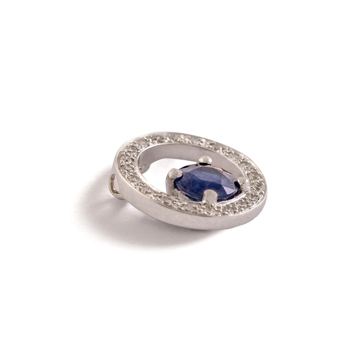 Sapphire and Diamond Circle Pendant. White gold 18K.
Sapphire Diameter: Approximately 4.79 millimeters.
Round cut Diamond Diameter: Approximately 1.10 millimeter.
Diameter: Approximately 1.90 centimeters.
Gross weight: 1.15 gram.

