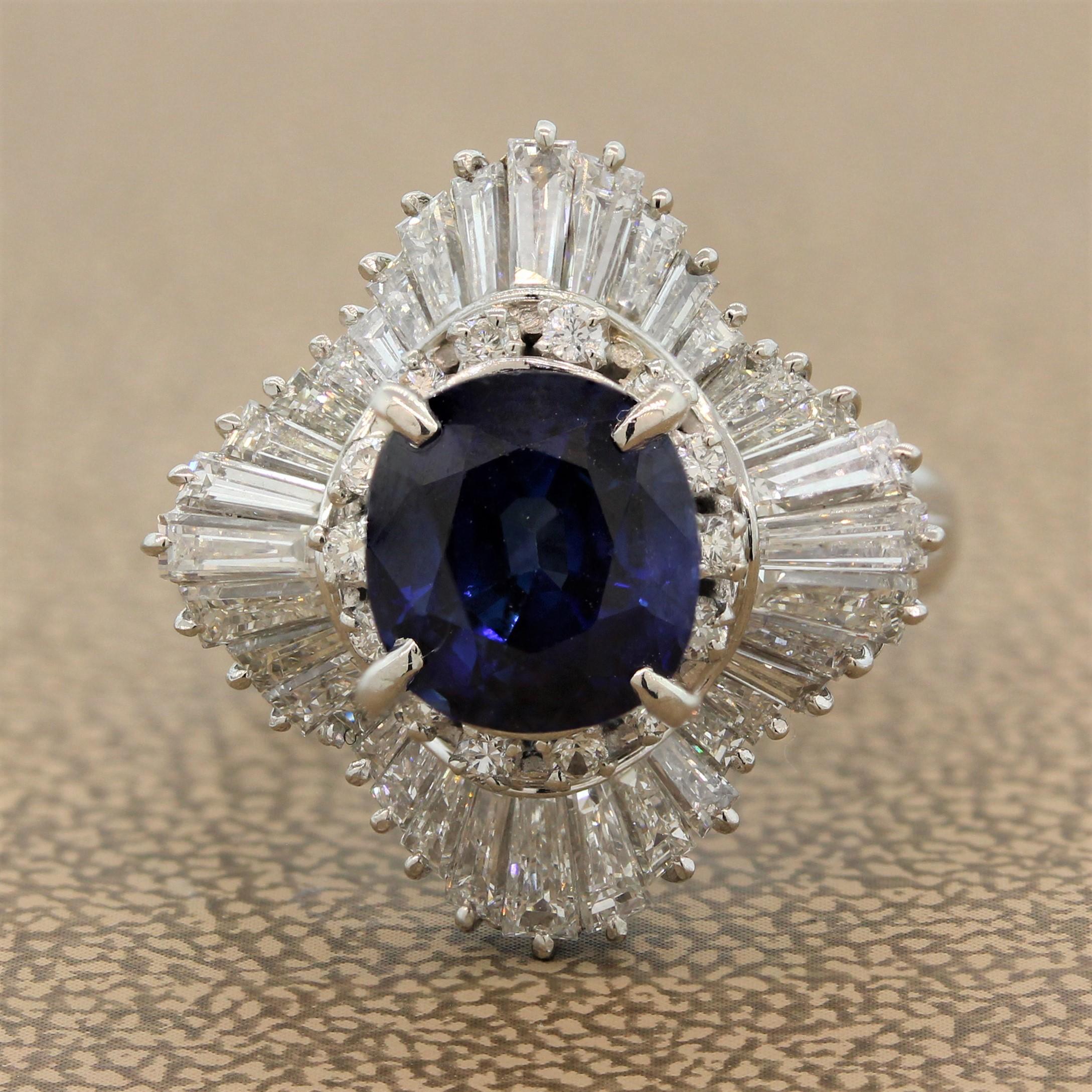 A delicate ballerina ring featuring a 3.14 carat blue sapphire which shows a vivid blue color. The cushion shaped sapphire has a double halo of tapered baguette and round cut diamonds weighting 1.80 carats which are set in a hand fabricated platinum