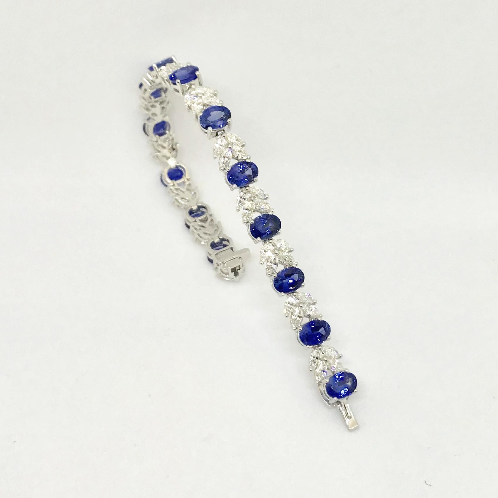 Platinum, 13-oval blue sapphires alternated with 13-sections of 4- marquise cut diamonds. The gems are mounted in prong basket settings. The fine blue, well-matched Ceylon sapphires total 18.44 cts, and the 52- diamonds total
7.70 cts that are